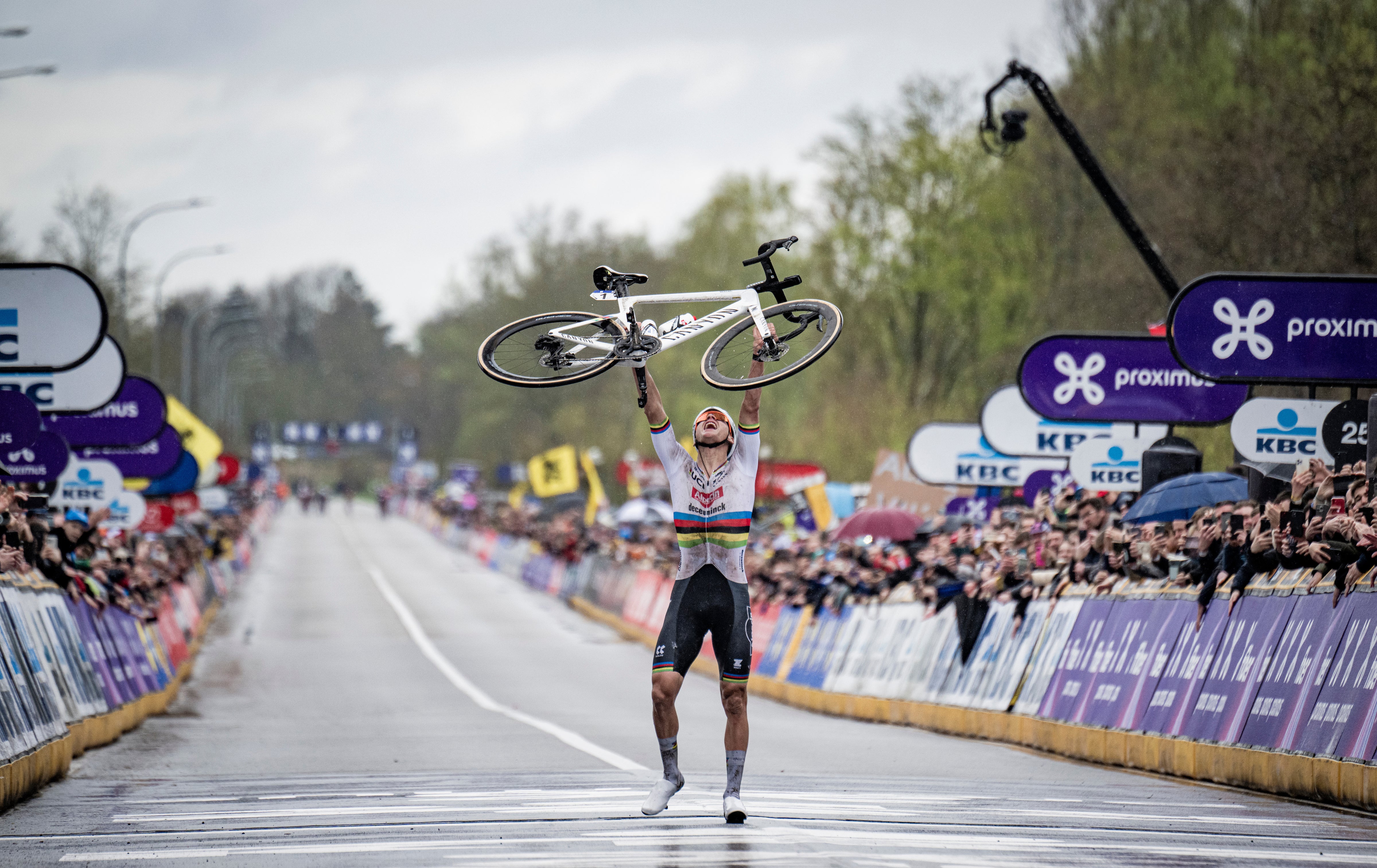 Van der Poel walks over the finish line with his bike aloft