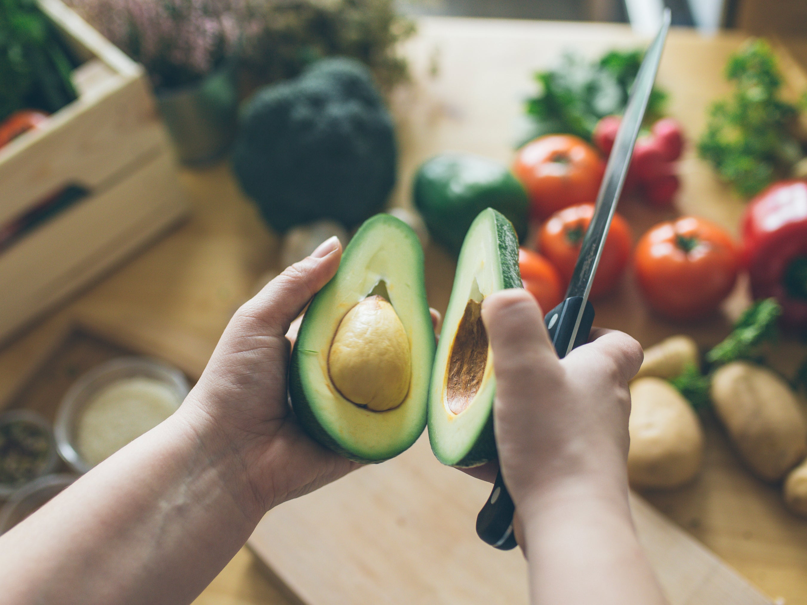 A man cutting an avocado in his kitchen (Getty Images)