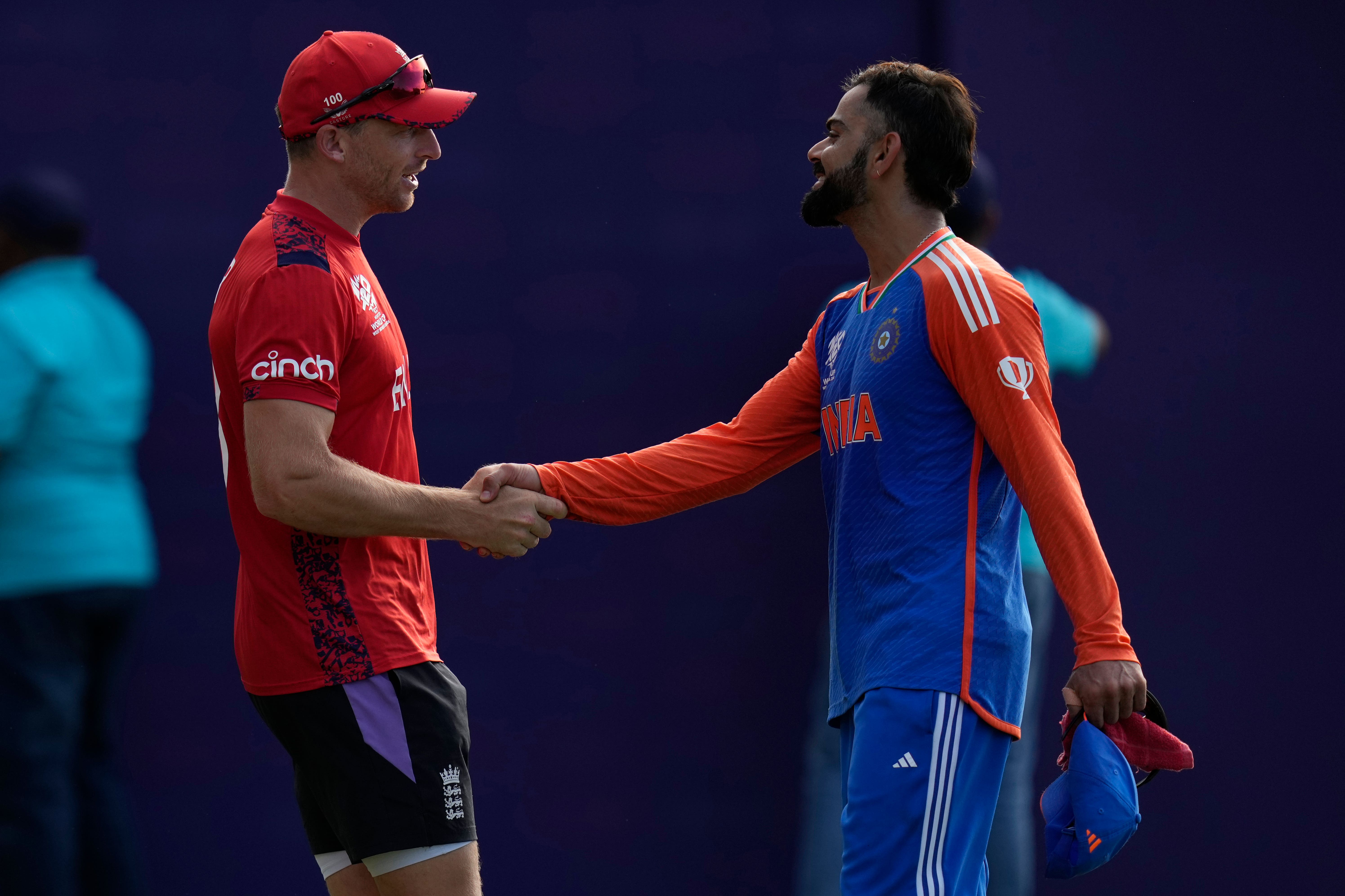 India’s Virat Kohli, right, gets congratulations from Jos Buttler