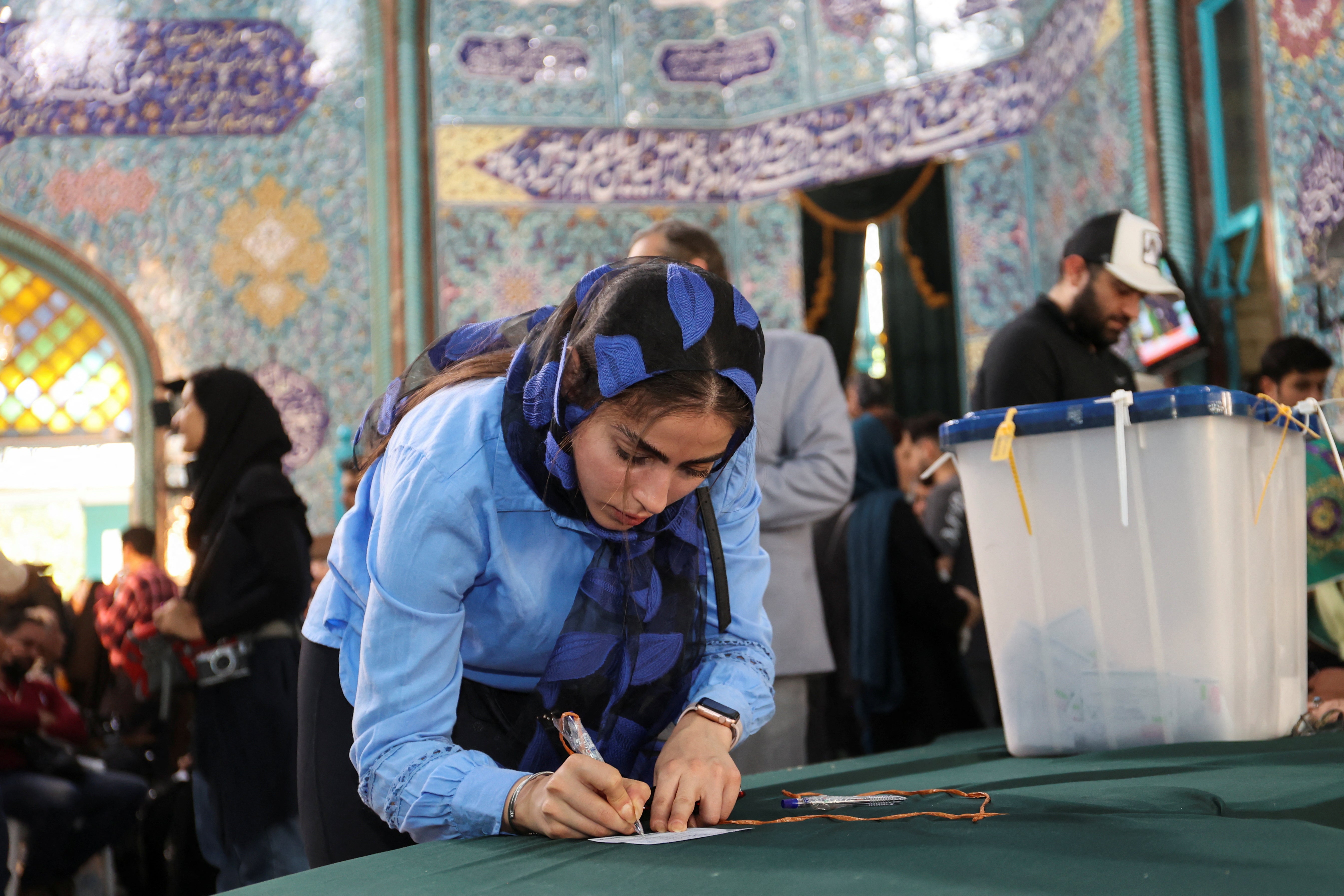 An Iranian woman votes at a polling station in Tehran