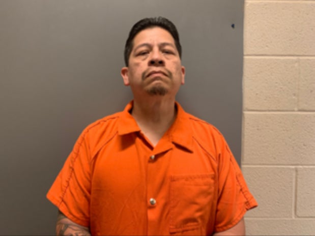 Adrian Gonzales, a former district officer, pictured in a booking photo. Gonzales was also charged with abandoning/endangering a child