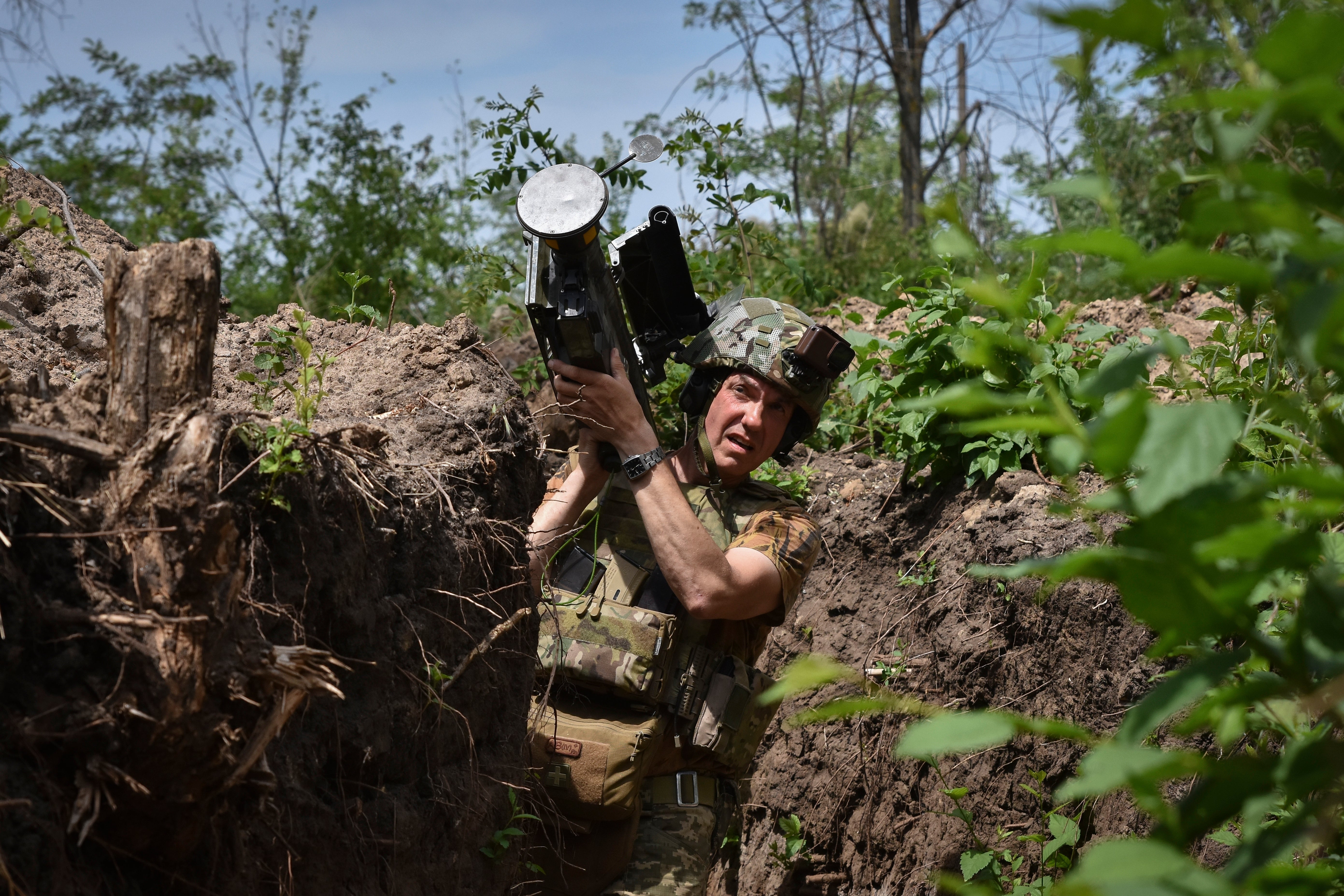 A Ukrainian serviceman carries a US Stinger air-defence missile launcher on the front line in the Zaporizhzhia region