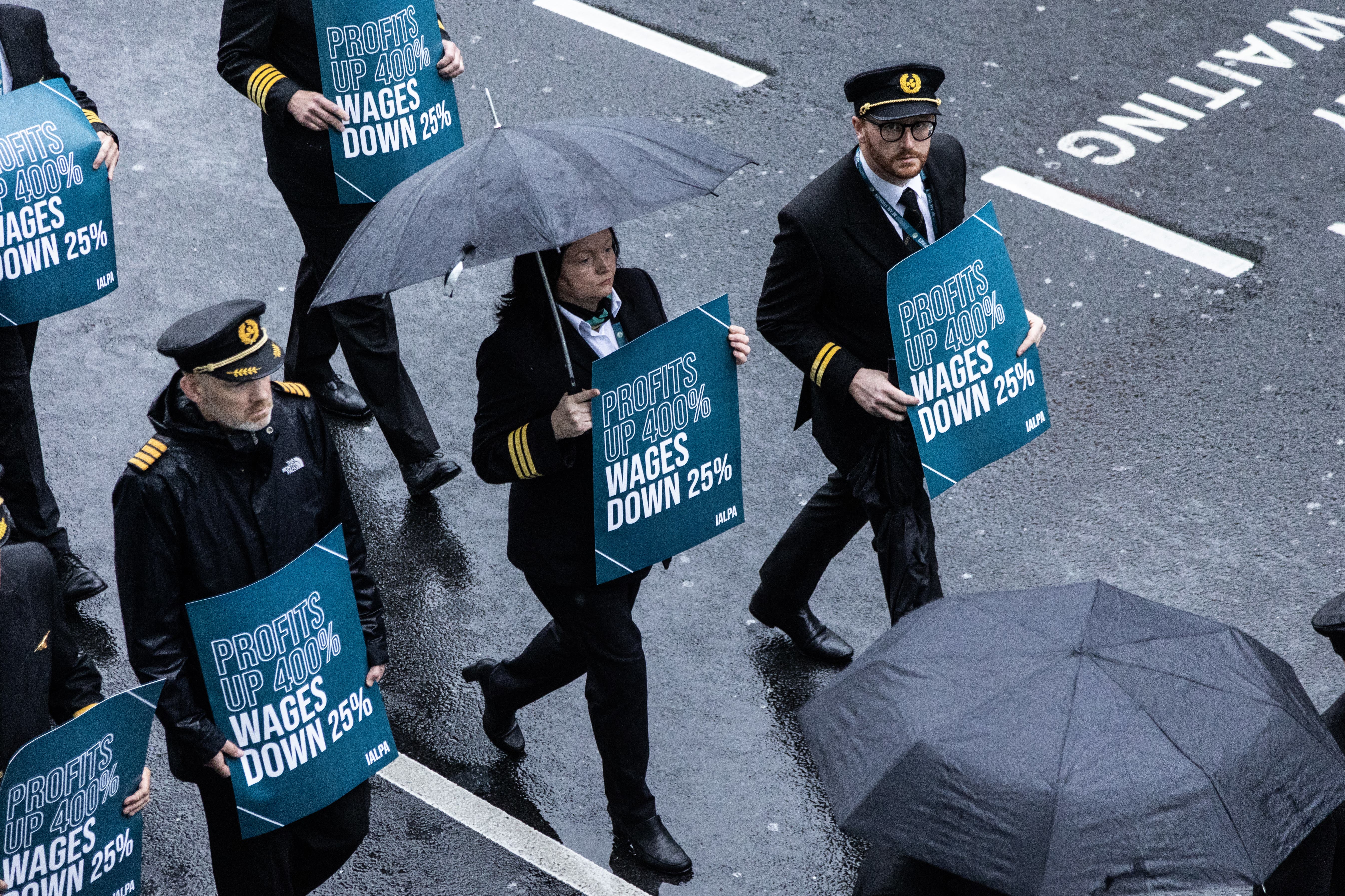 Aer Lingus pilots march around Dublin Airport as they begin their eight-hour strike (Evan Treacy/PA)