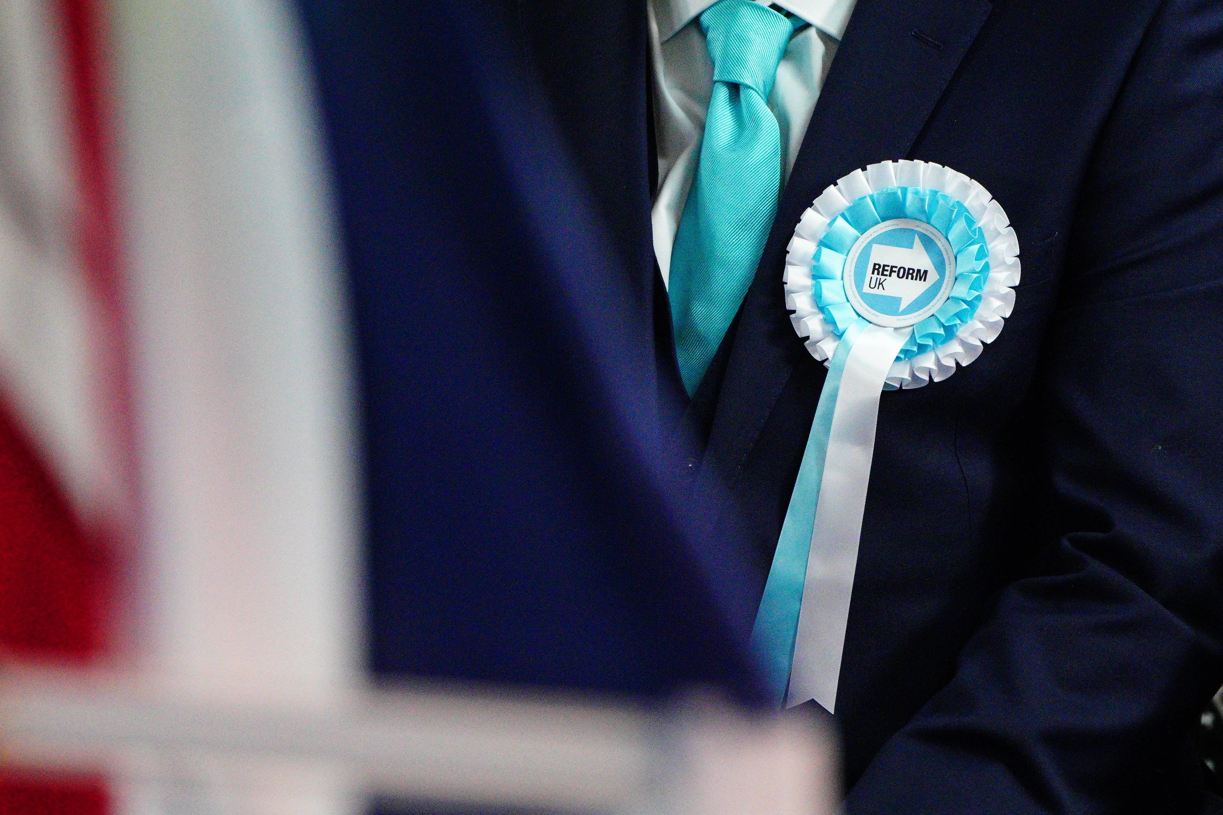 A person wearing a Reform UK rosette at the party’s launch of ‘Our Contract with You’ in Merthyr Tydfil (Ben Birchall/PA)