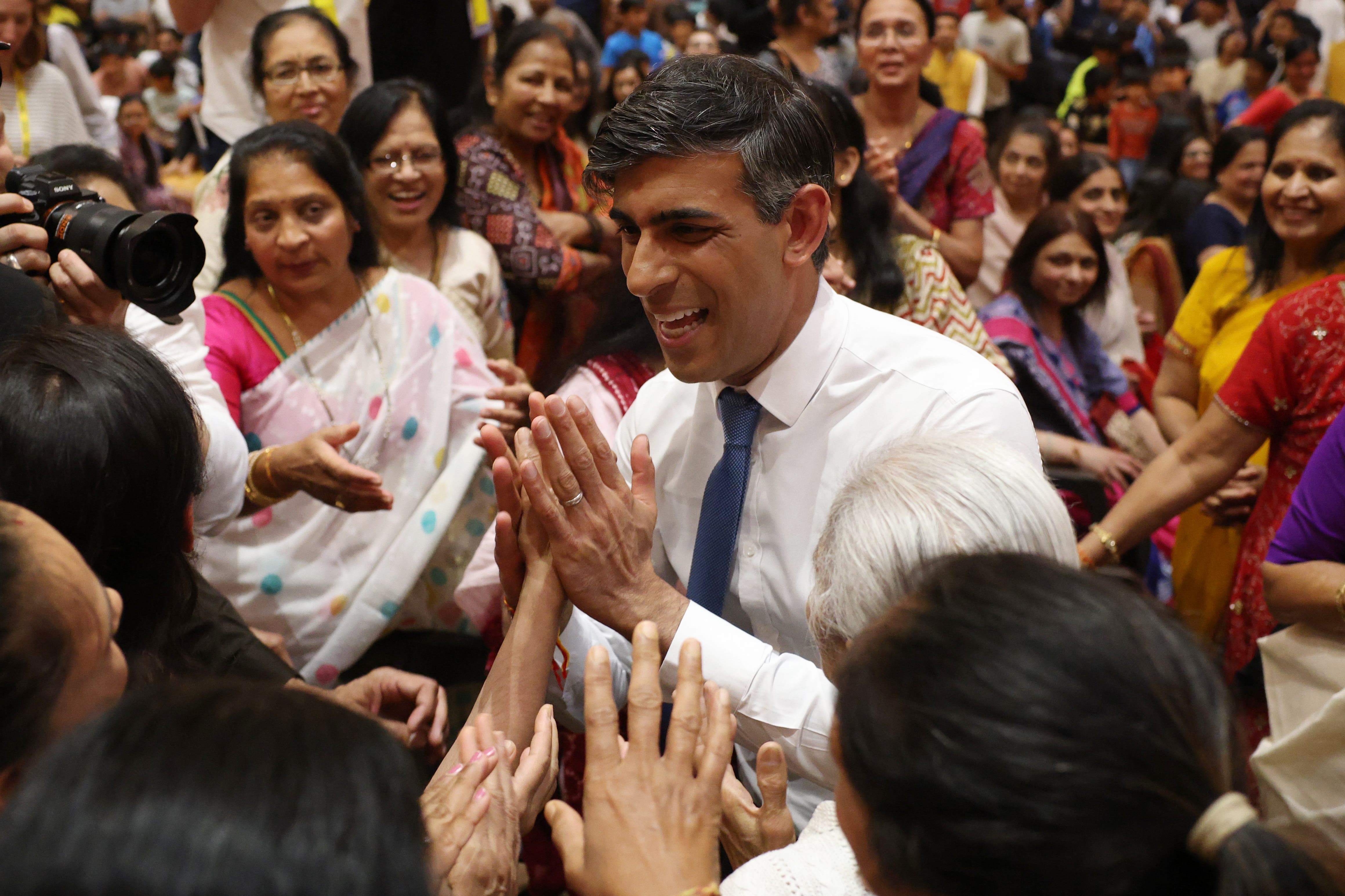 Prime Minister Rishi Sunak greets people during a visit to BAPS Shri Swaminarayan Mandir (PA)