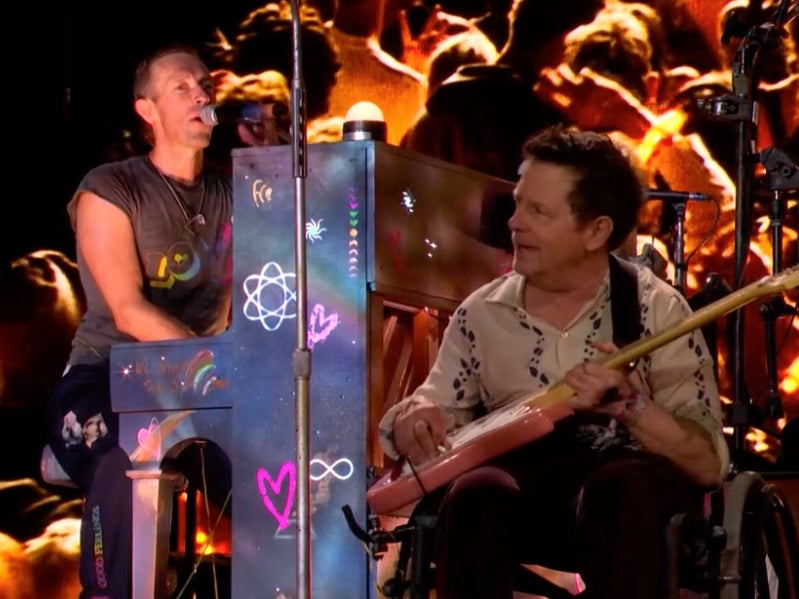 Chris Martin performs with Michael J Fox on the Pyramid Stage at Glastonbury