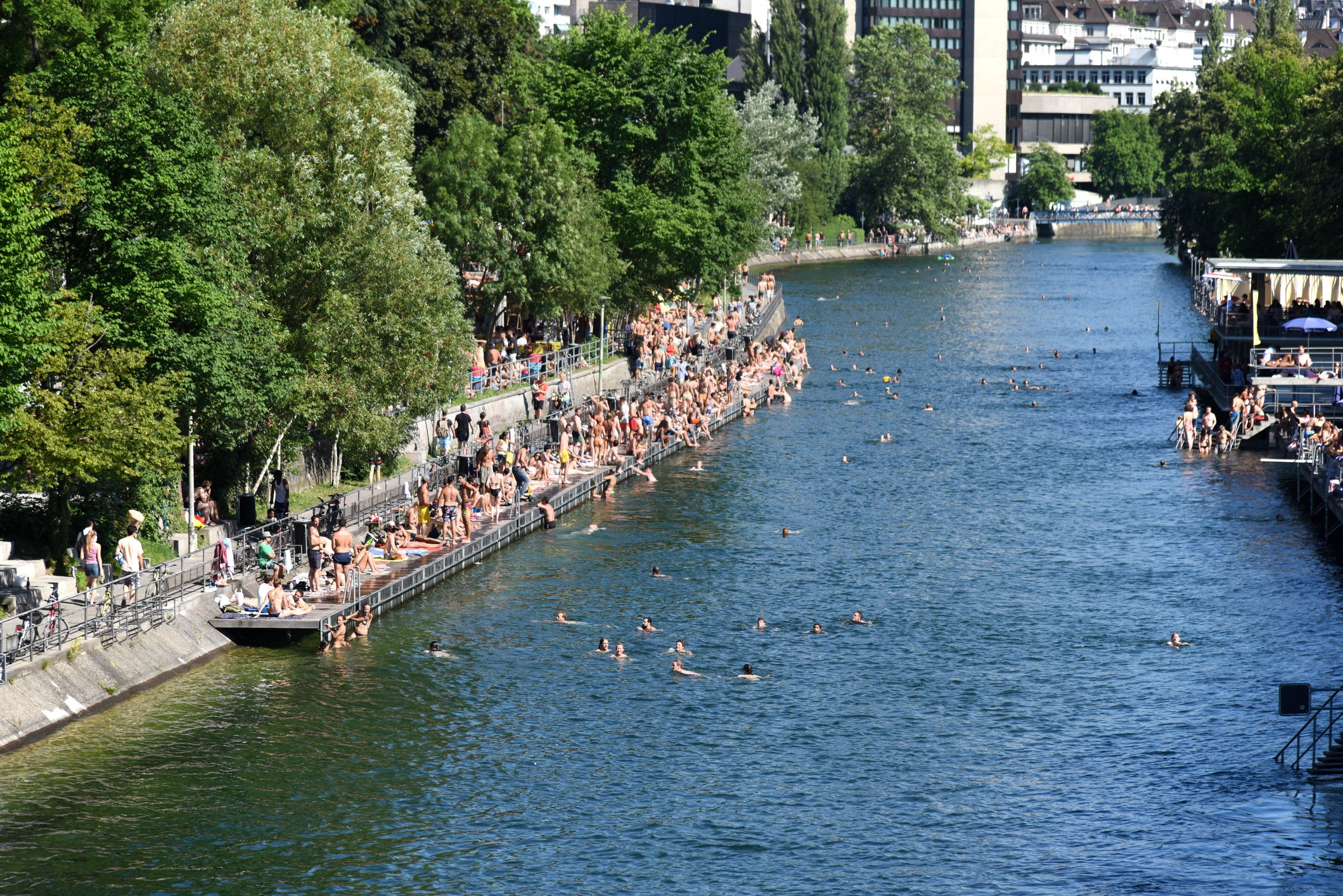 Groups of people cooling off in the Limmat