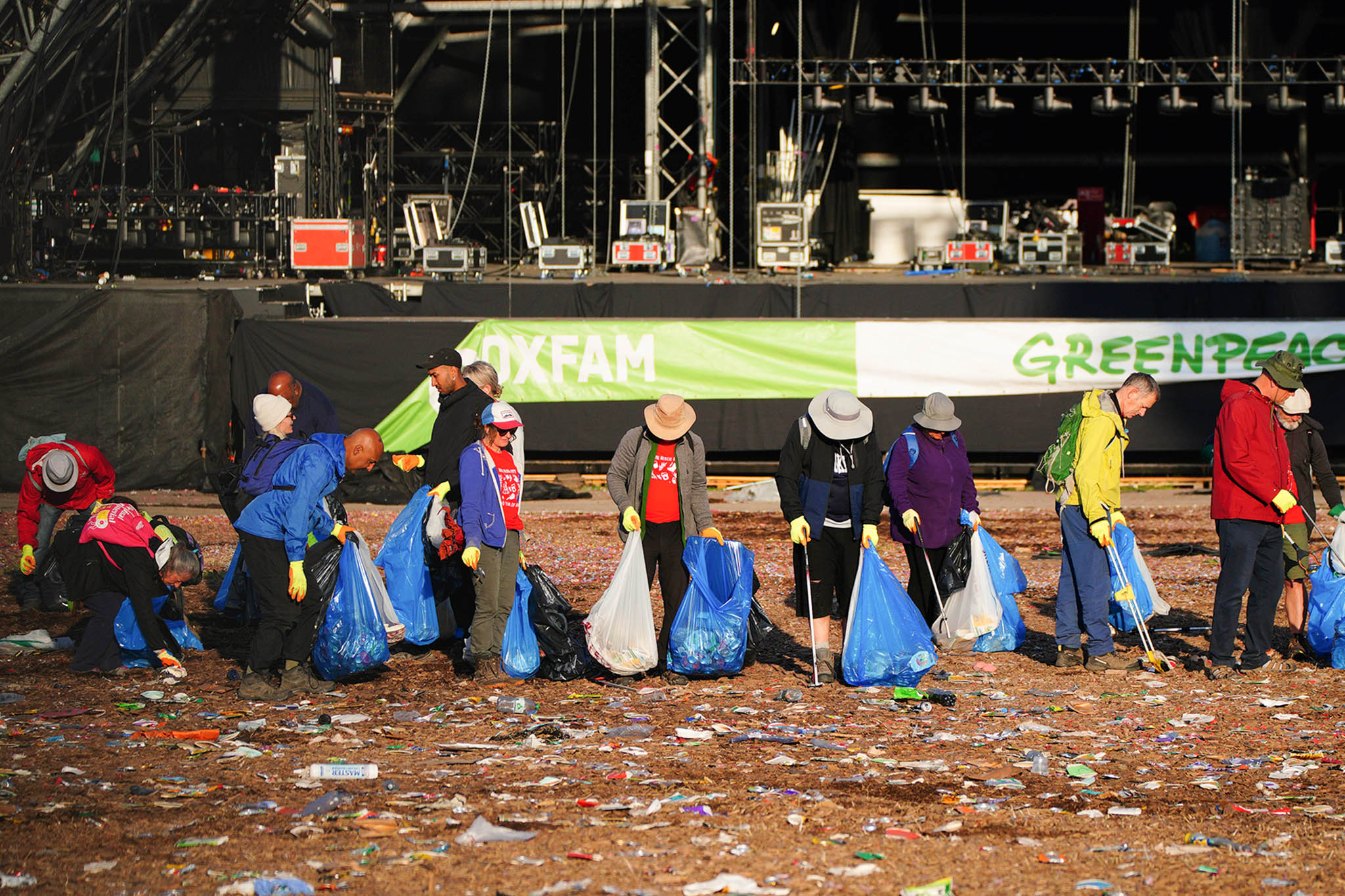 Litter pickers get to work on Monday morning by the Pyramid Stage