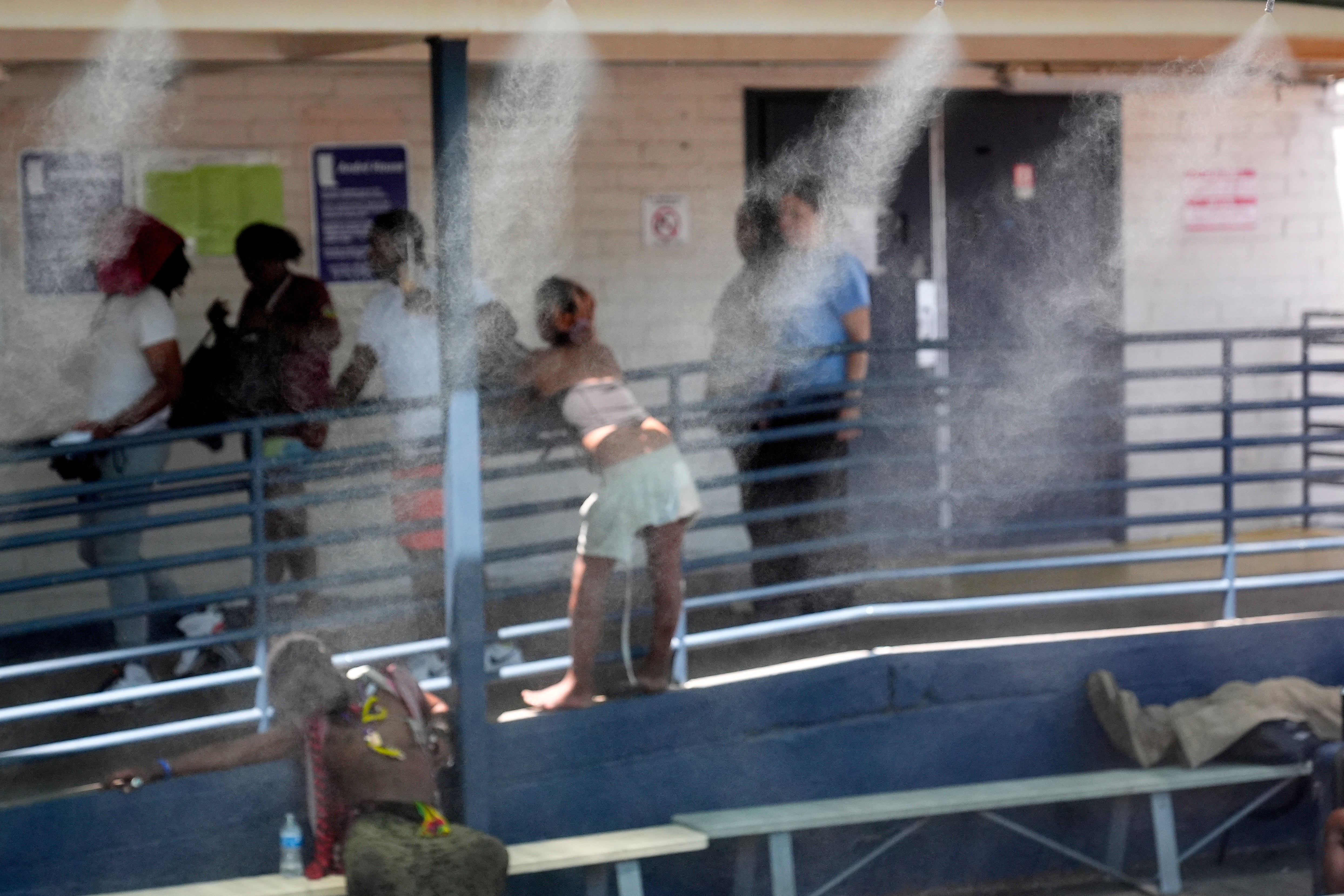 Homeless people gather outside one of five Circle The City mobile clinics stationed outside a soup kitchen, Thursday, May 30, 2024 in Phoenix