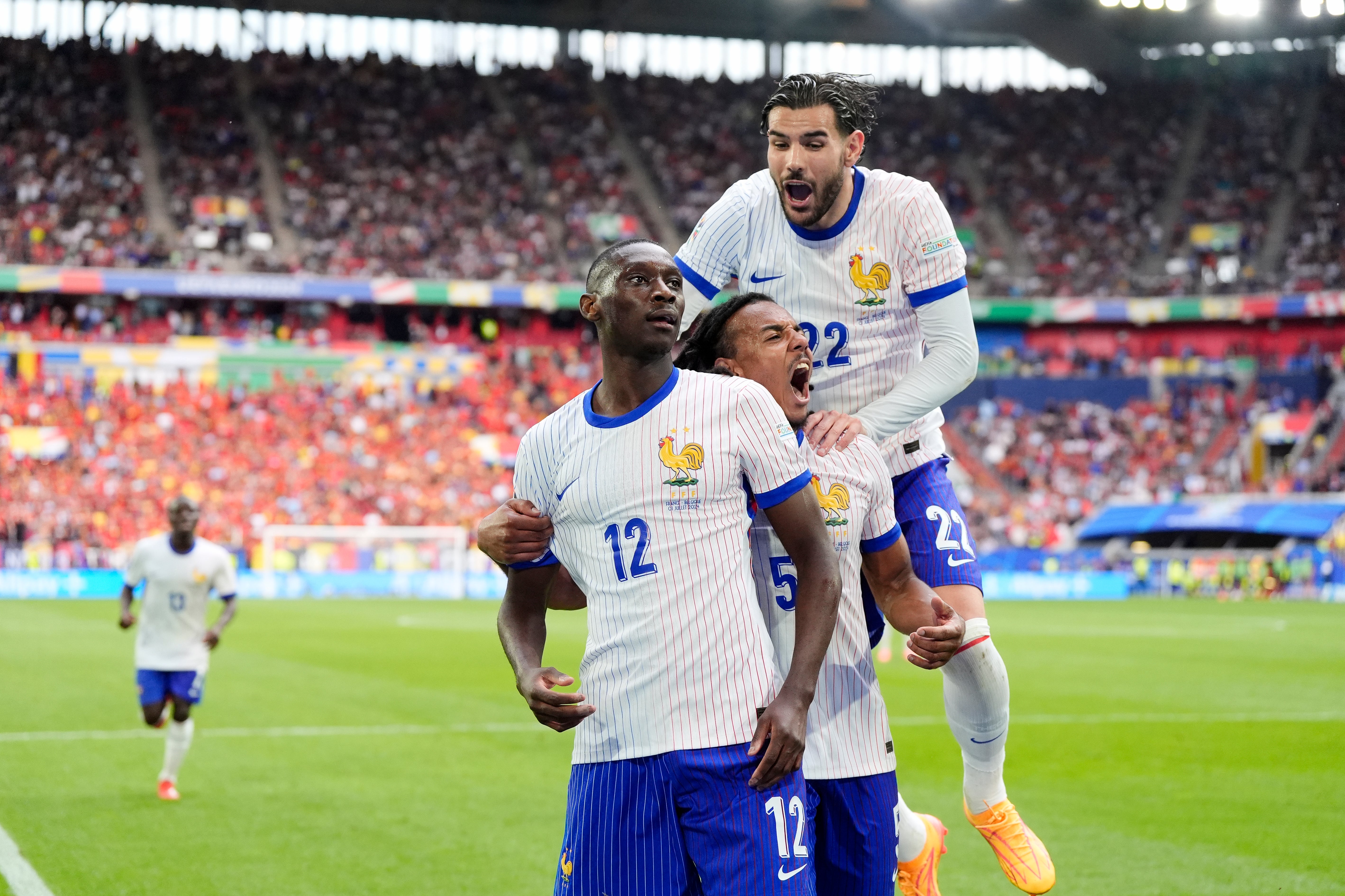 France celebrate after Randal Kolo Muani’s deflected shot found the Belgian net