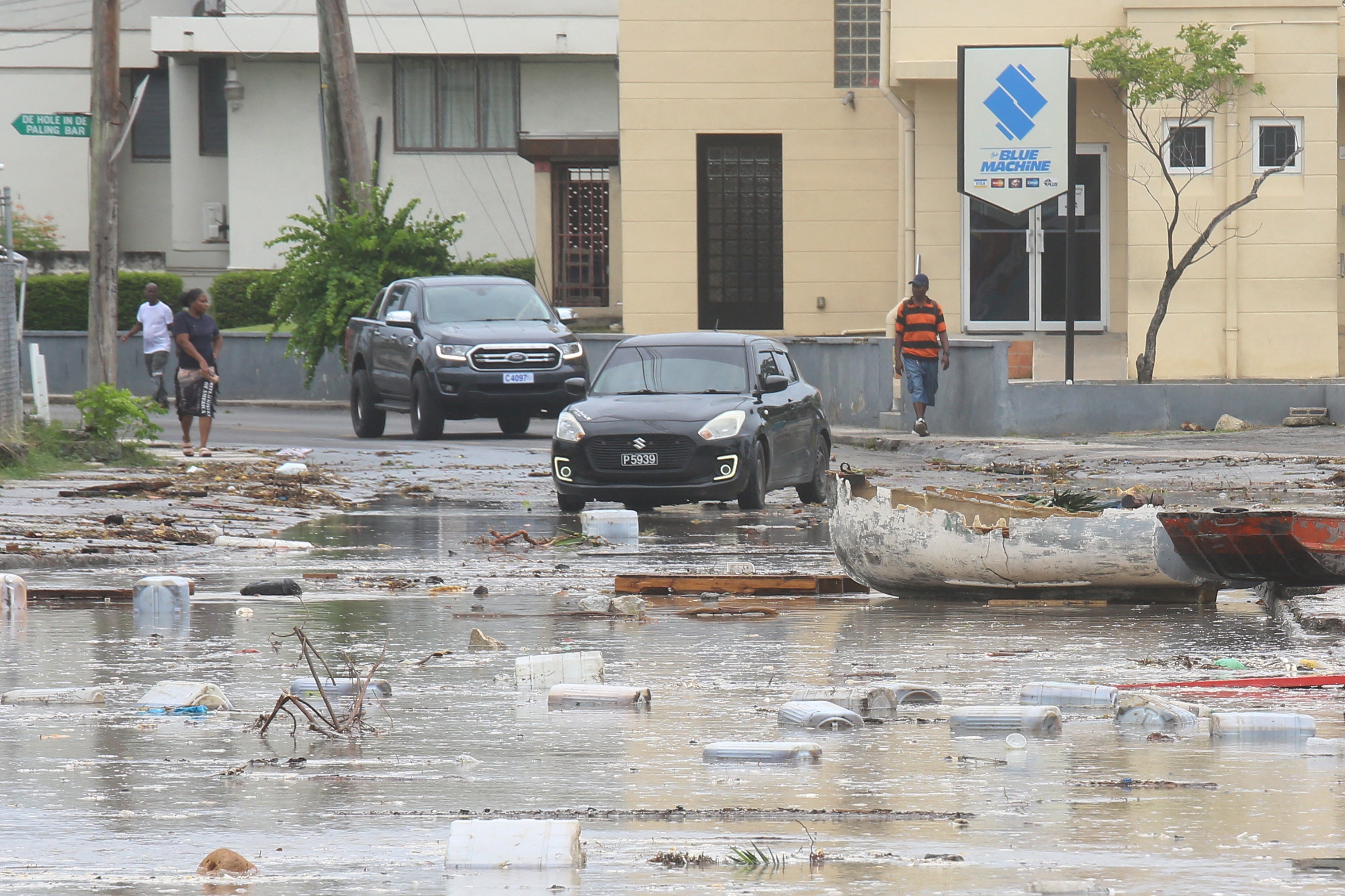 Cars drive through a debris-filled street in Bridgetown, Barbados after Hurricane Beryl blew through the island. AccuWeather is now warning about how its post on X about the path got a community note, but misinformation has not.