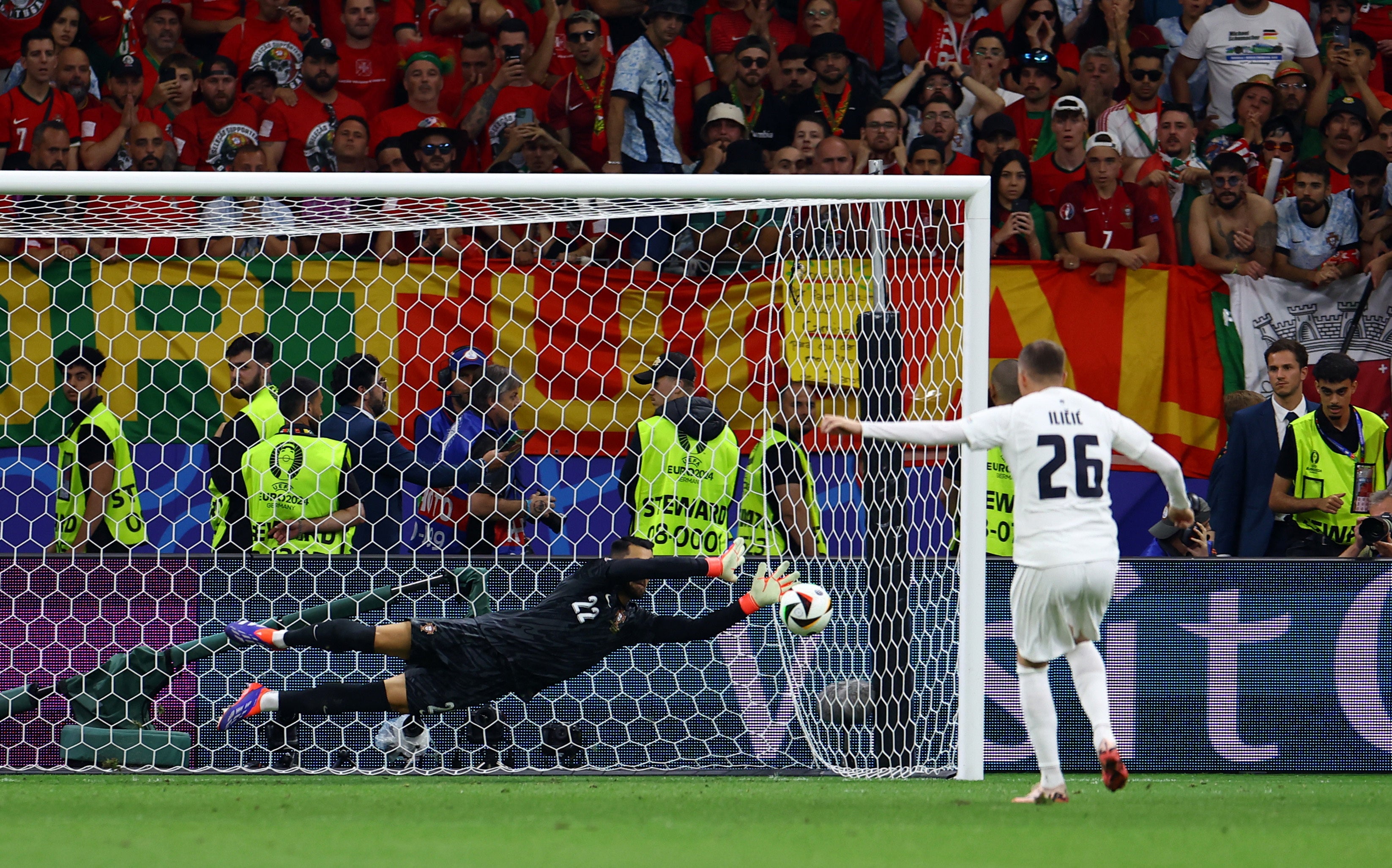 Diogo Costa saves a penalty from Slovenia’s Josip Ilicic