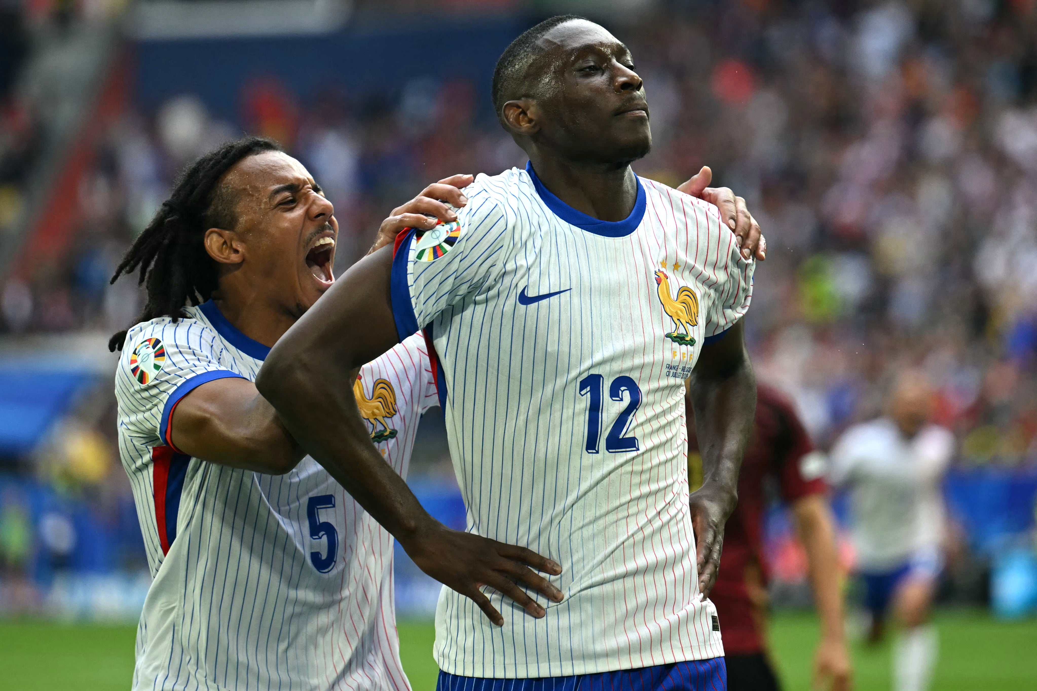 Kounde, left, celebrates after Randal Kolo Muani’s deflected strike breached Belgium