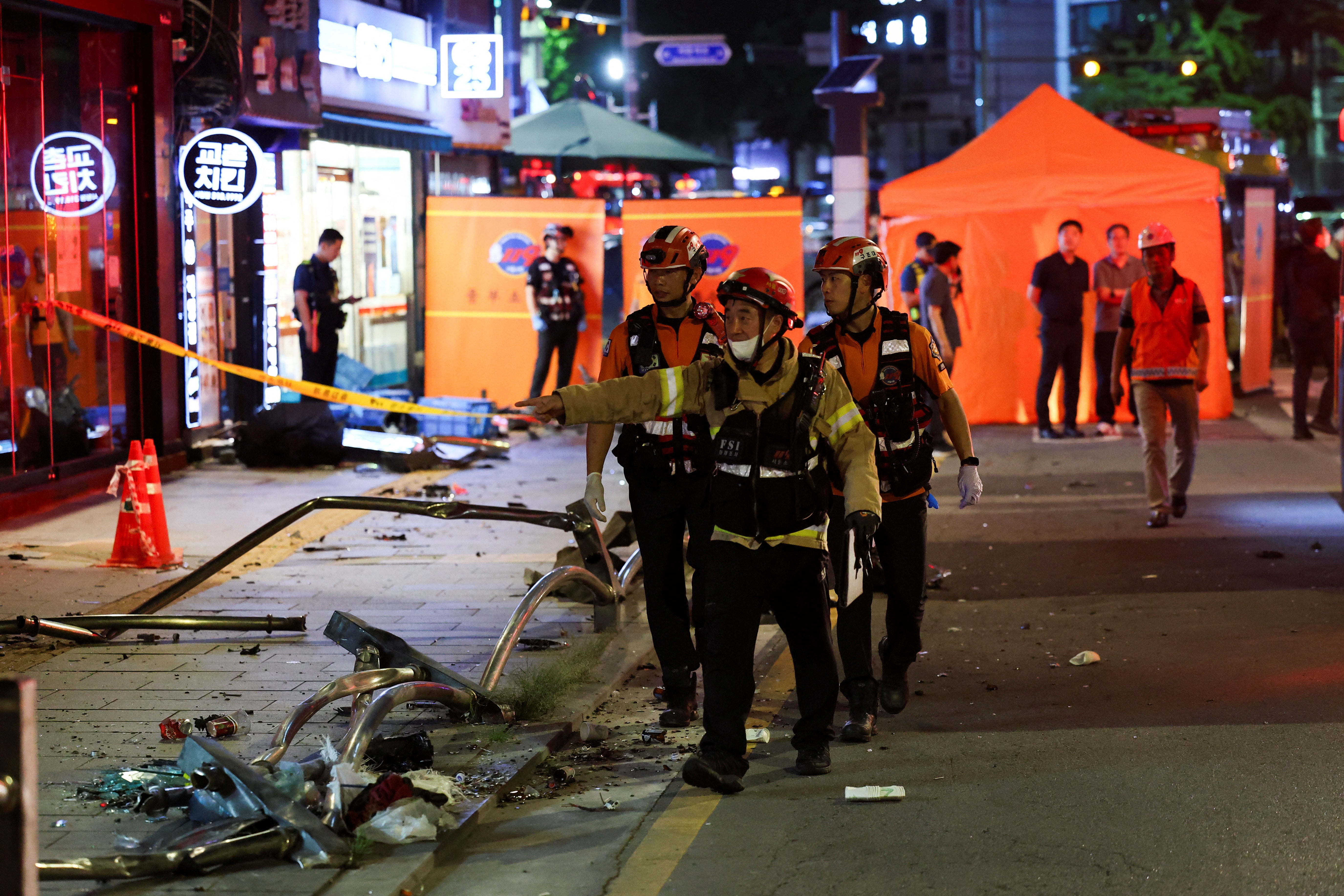 Rescuers work at the scene of car accident that resulted in several people killed and injured in central Seou