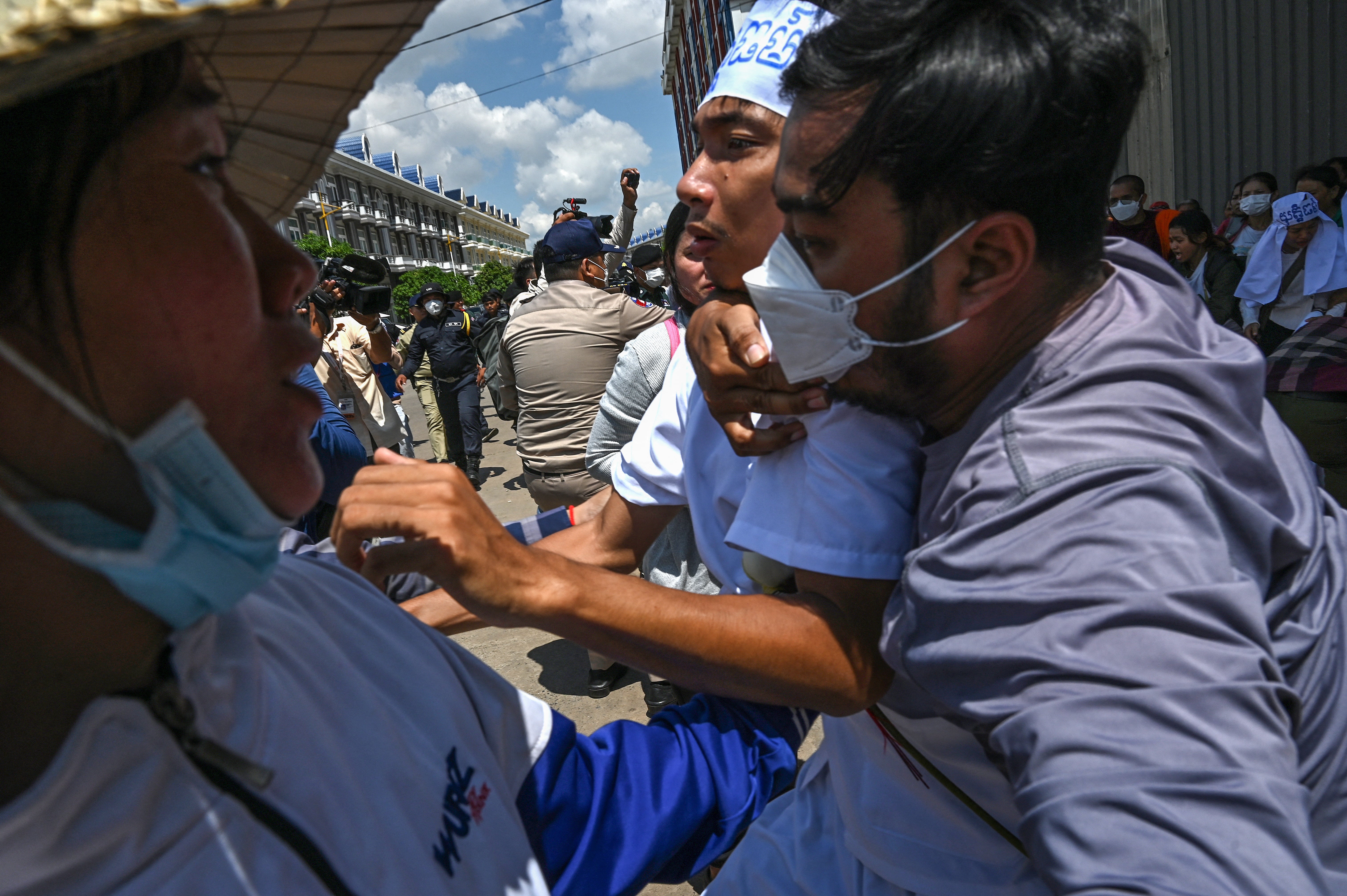 Cambodian environmental activist Ly Chandraravuth (C) is arrested outside Phnom Penh municipal court after a verdict in Phnom Penh