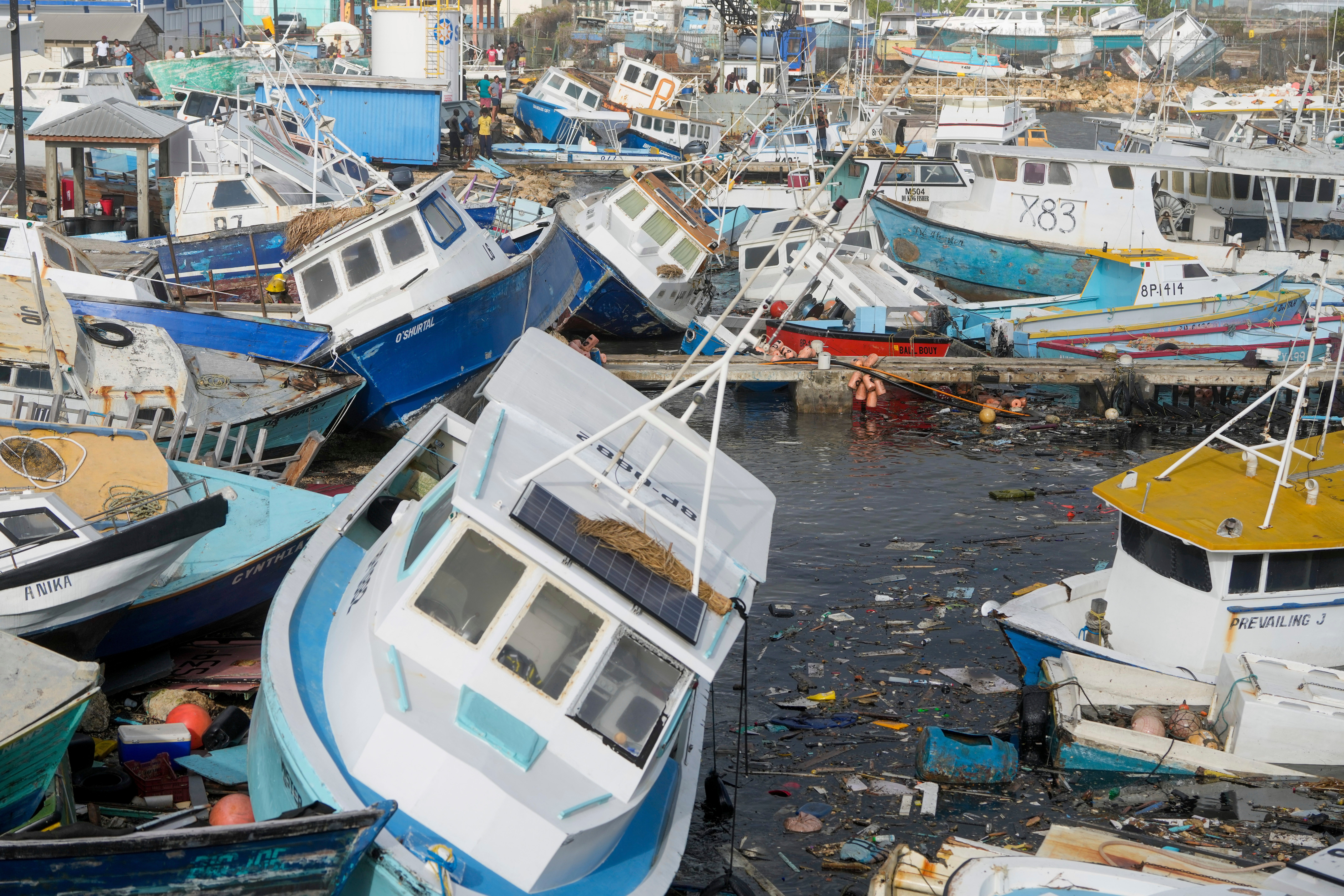 Fishing vessels damaged by Hurricane Beryl sit upended at the Bridgetown Fisheries in Barbados, Monday, July 1, 2024. (AP Photo/Ricardo Mazalan)