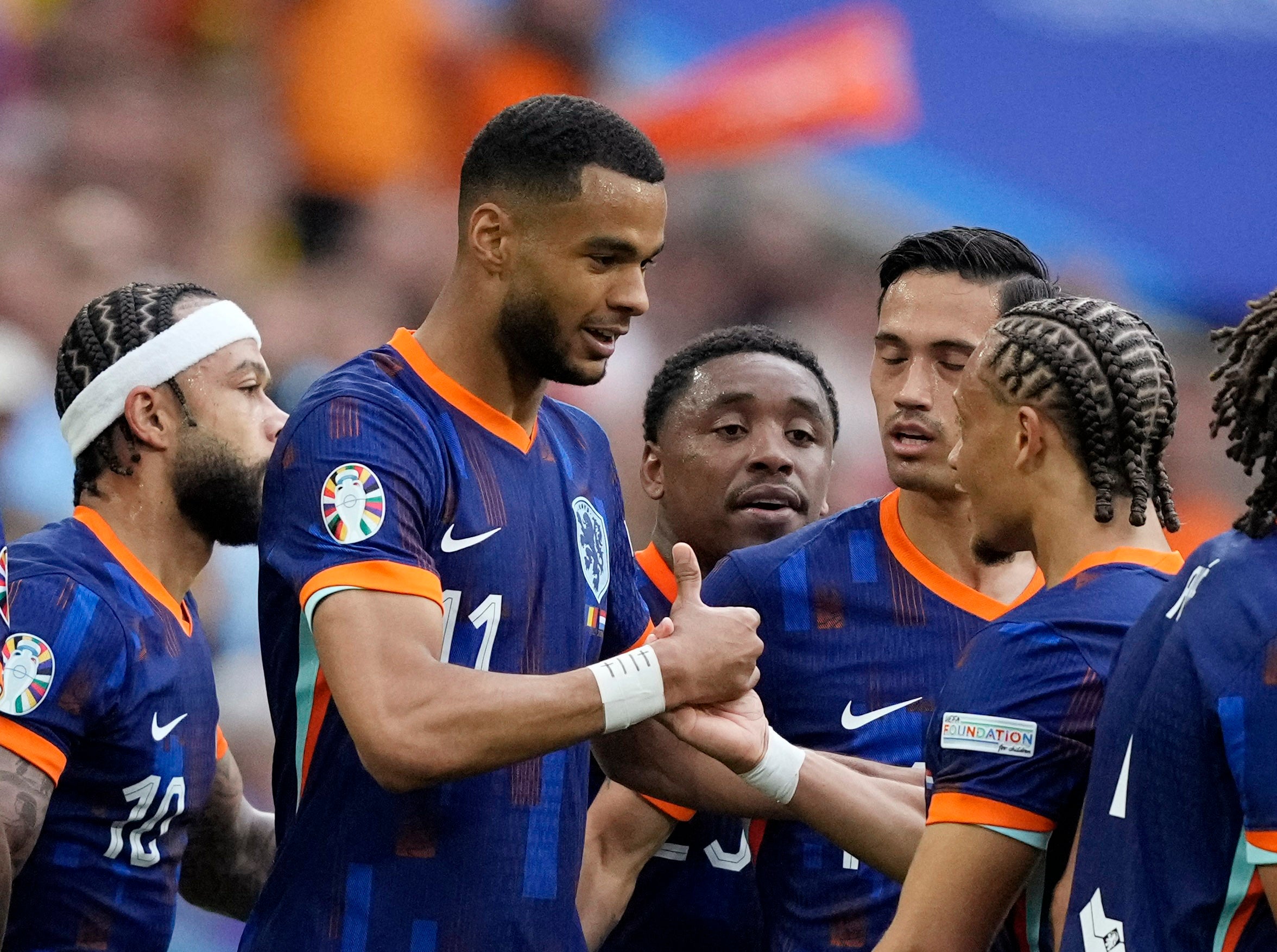 Cody Gakpo celebrates with Xavi Simons after scoring the first Netherlands goal in Munich’s Allianz Arena