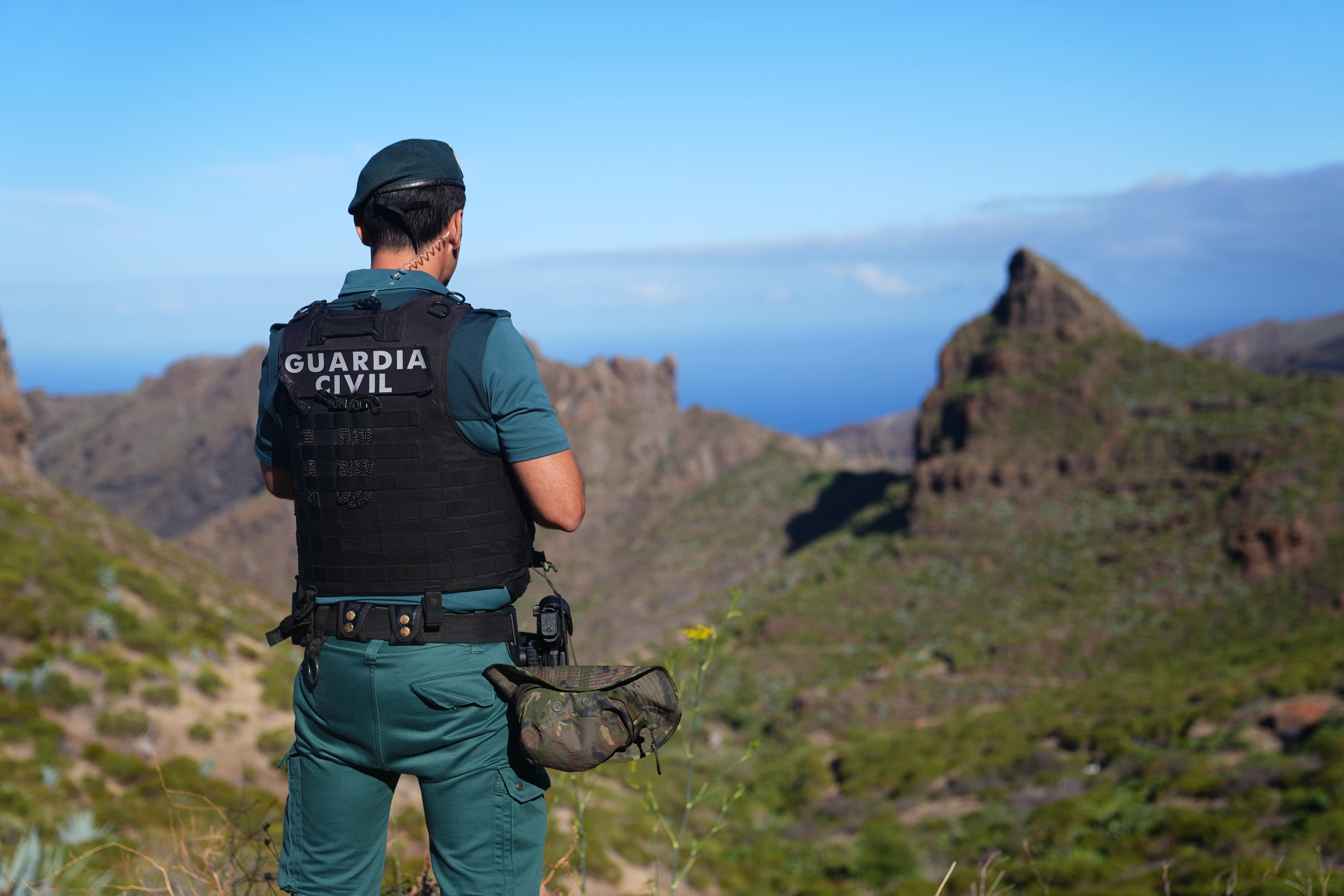 A Spanish police officer looks over the village of Masca, Tenerife, during the search for the missing British teenager