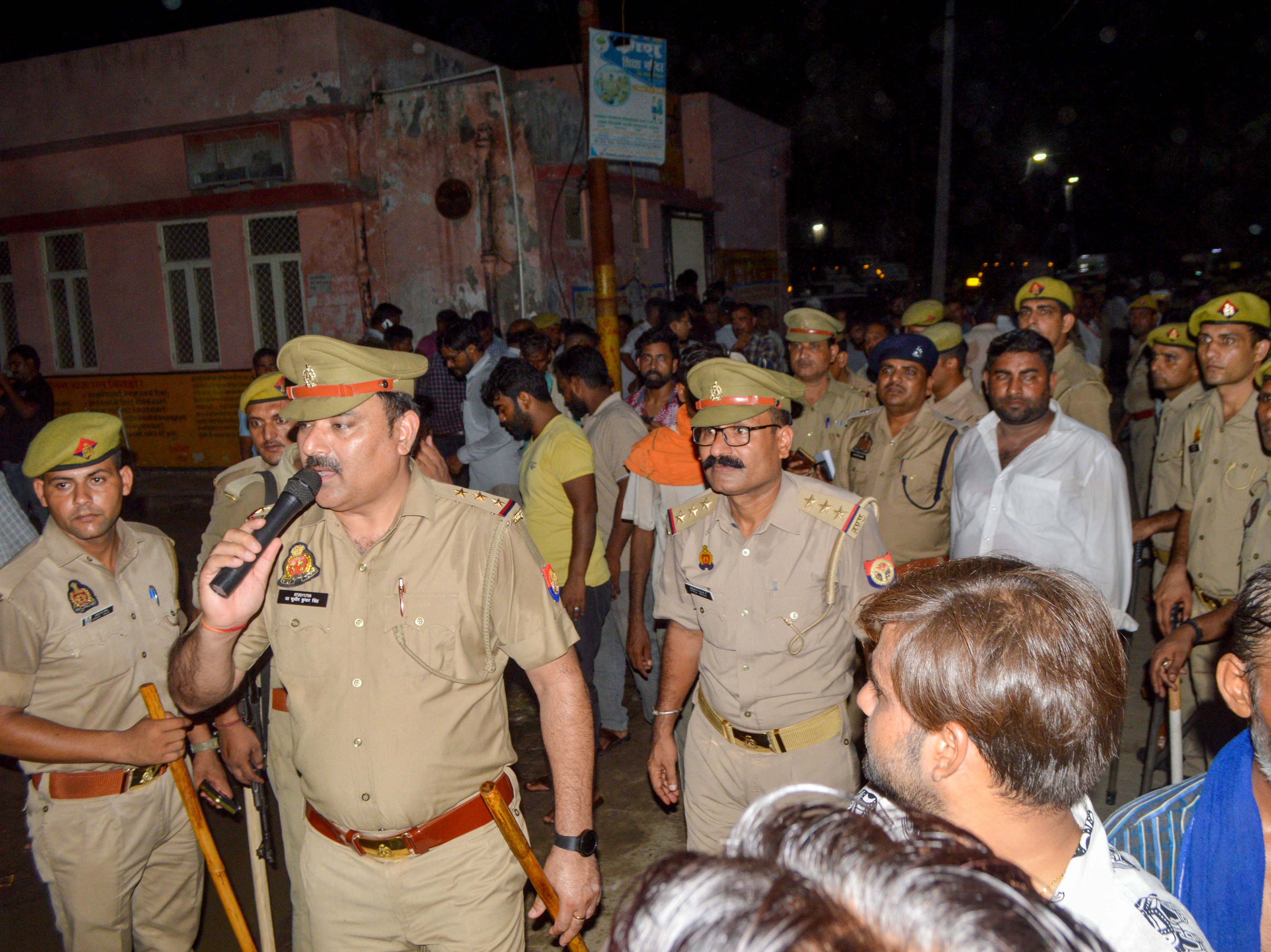 Police manage the mourners as bodies of the victims of the Hathras stampede are brought to a hospital in Uttar Pradesh on 2 July 2024