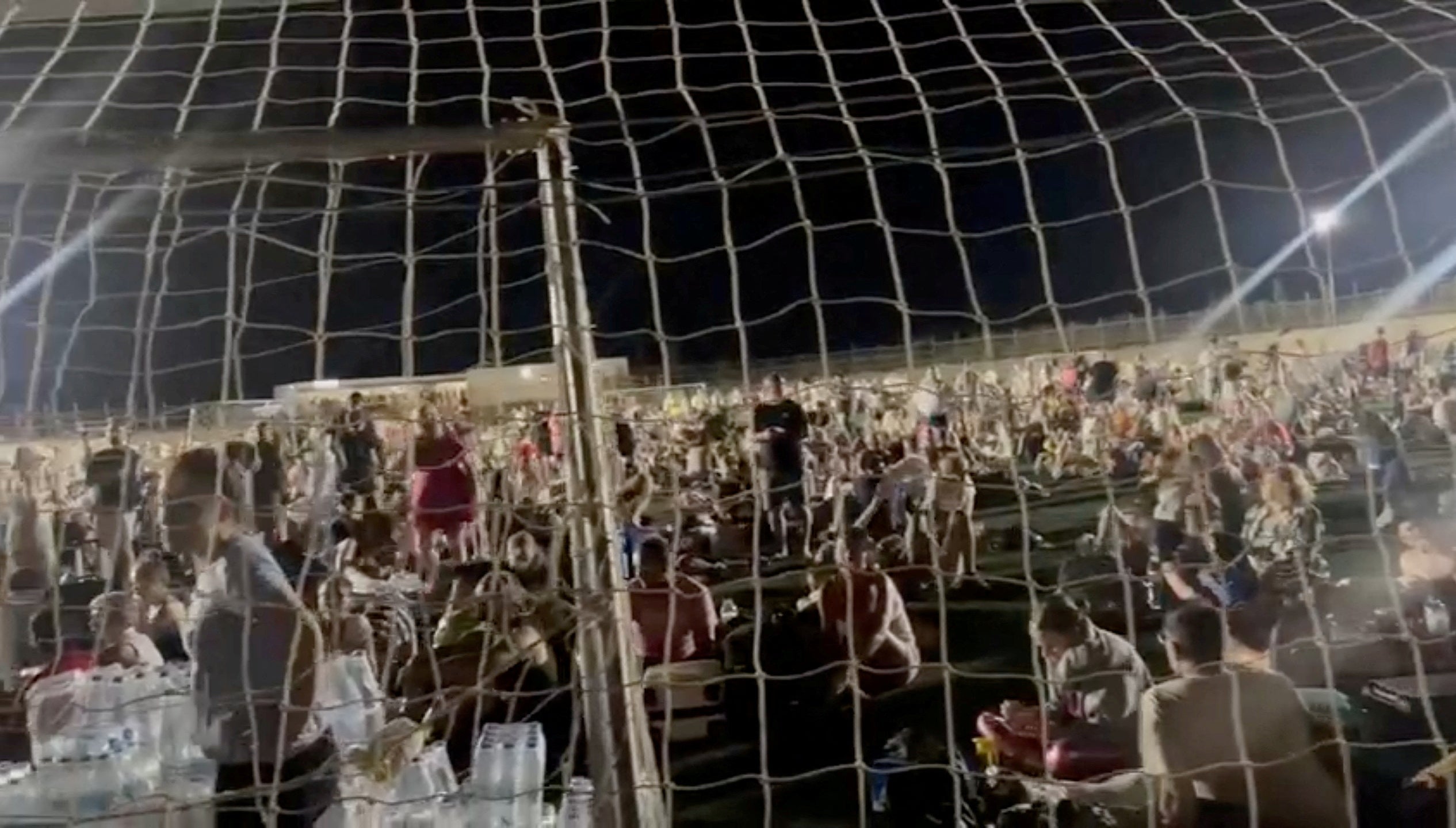 People gather at a football field following fire around the island of Kos, Greece