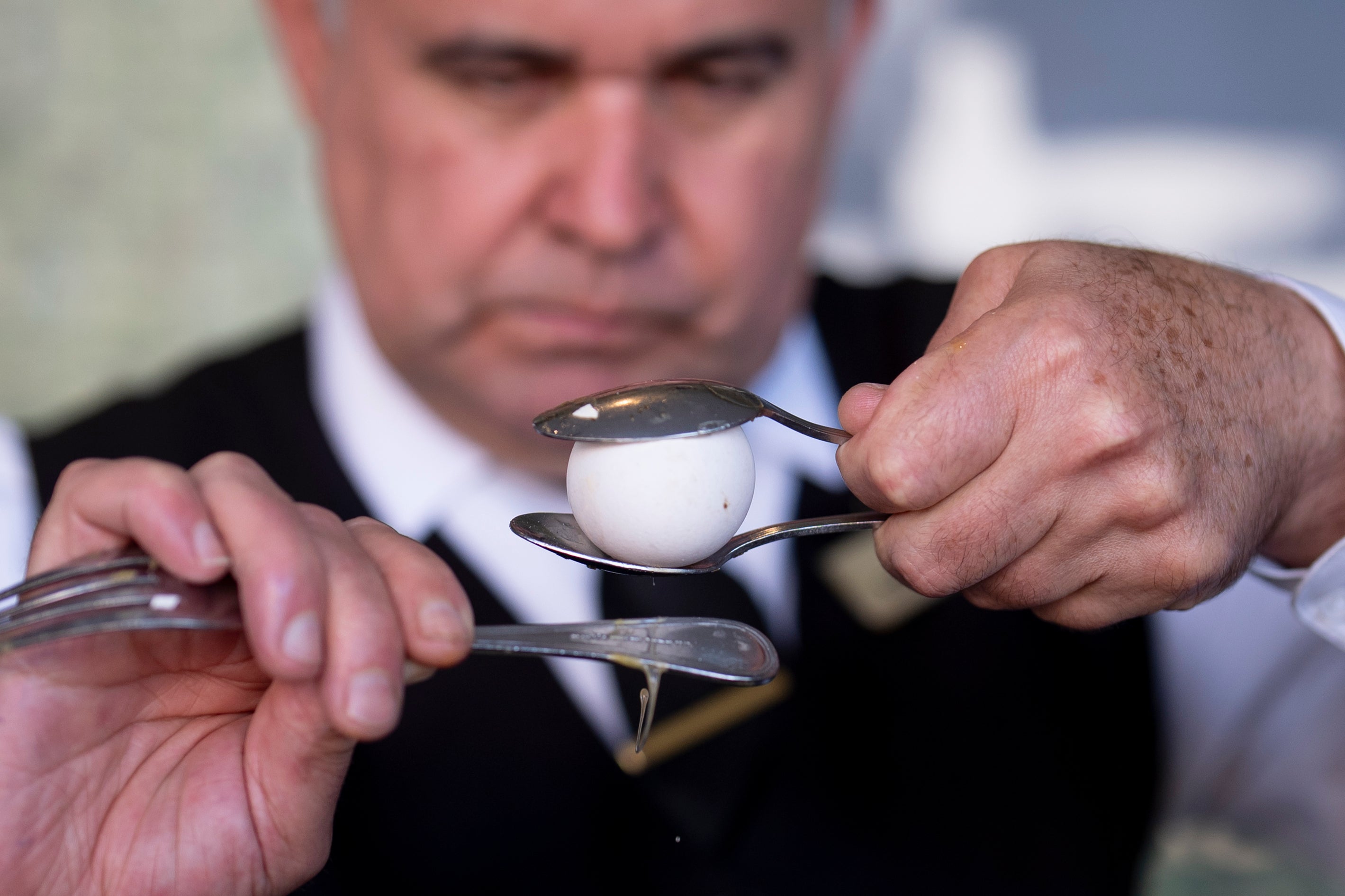 Salad Master Efrain Montoya cracks an egg as he prepares a Caesar salad at Ceasar’s restaurant Thursday, June 27, 2024