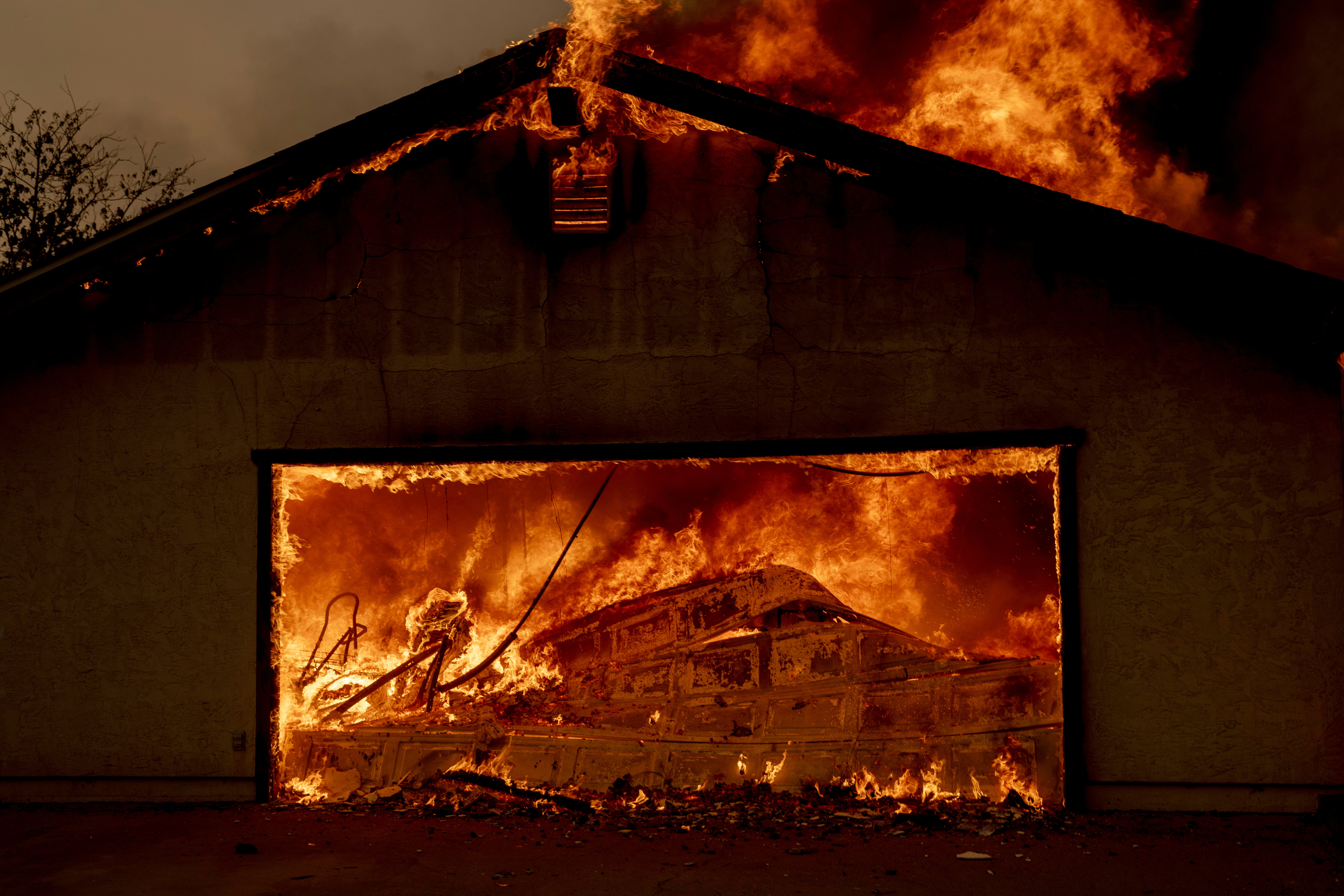 A home is engulfed in flames during the Thompson Fire in northern California last month. Stanford University researchers say their gel could protect homes like these for longer than current commercial gels.