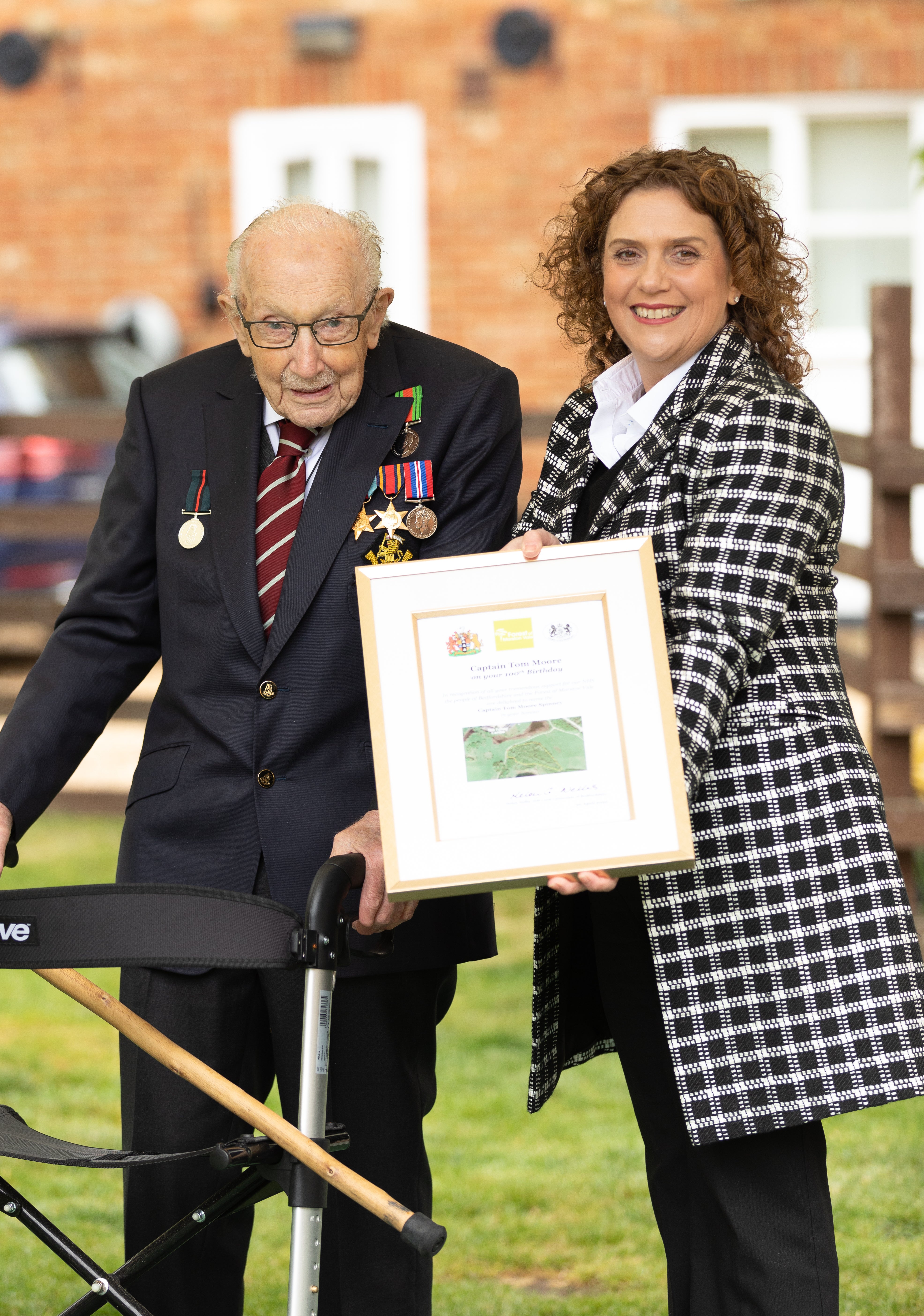 Sir Captain Tom Moore with his daughter Hannah as he celebrated his 100th birthday - it was not long after that a family-owned company won a trade mark for his name (Emma Sohl/Capture the Light Photography/PA)