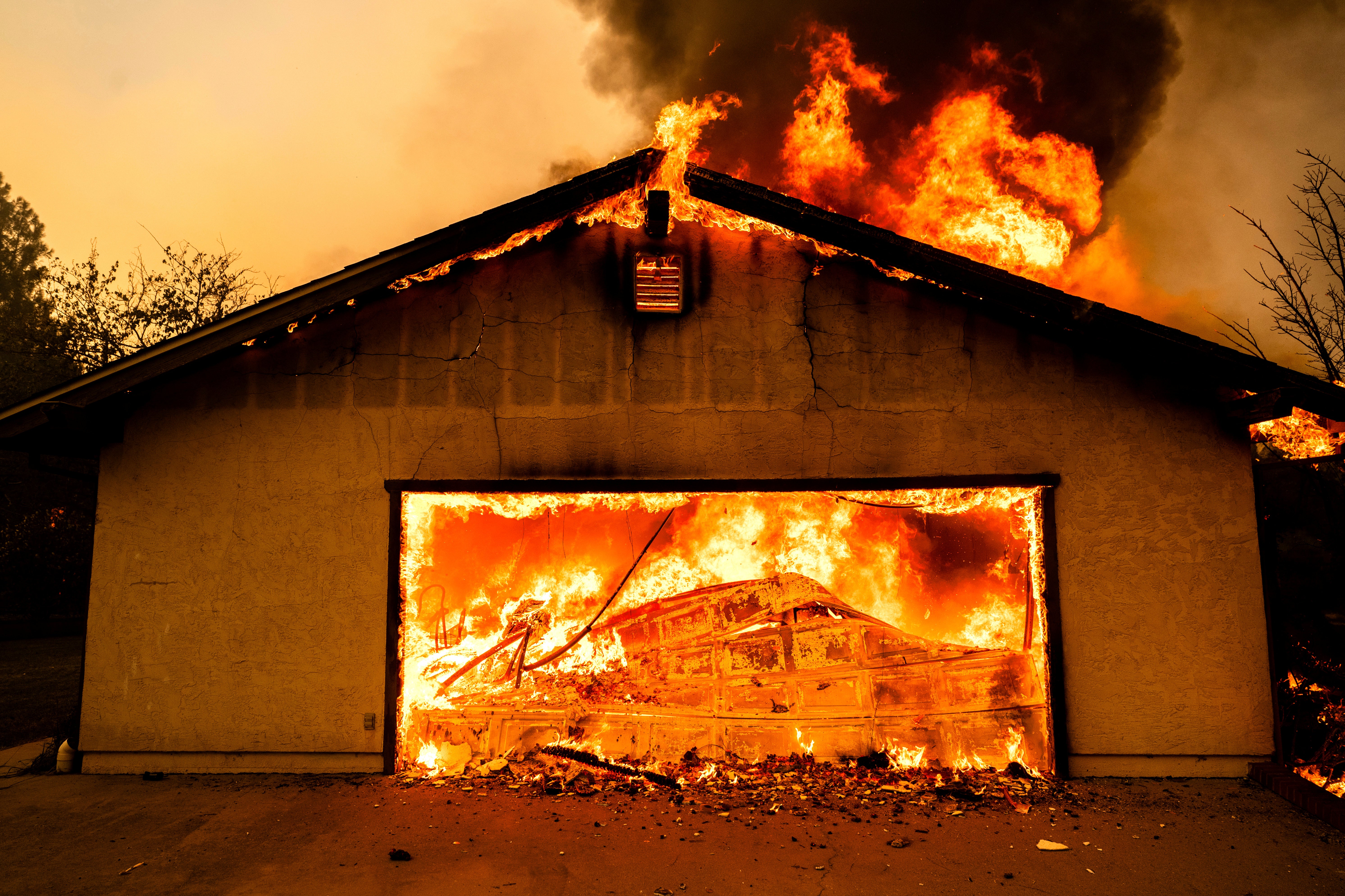 The fire has engulfed houses, vehicles and nearby forested areas