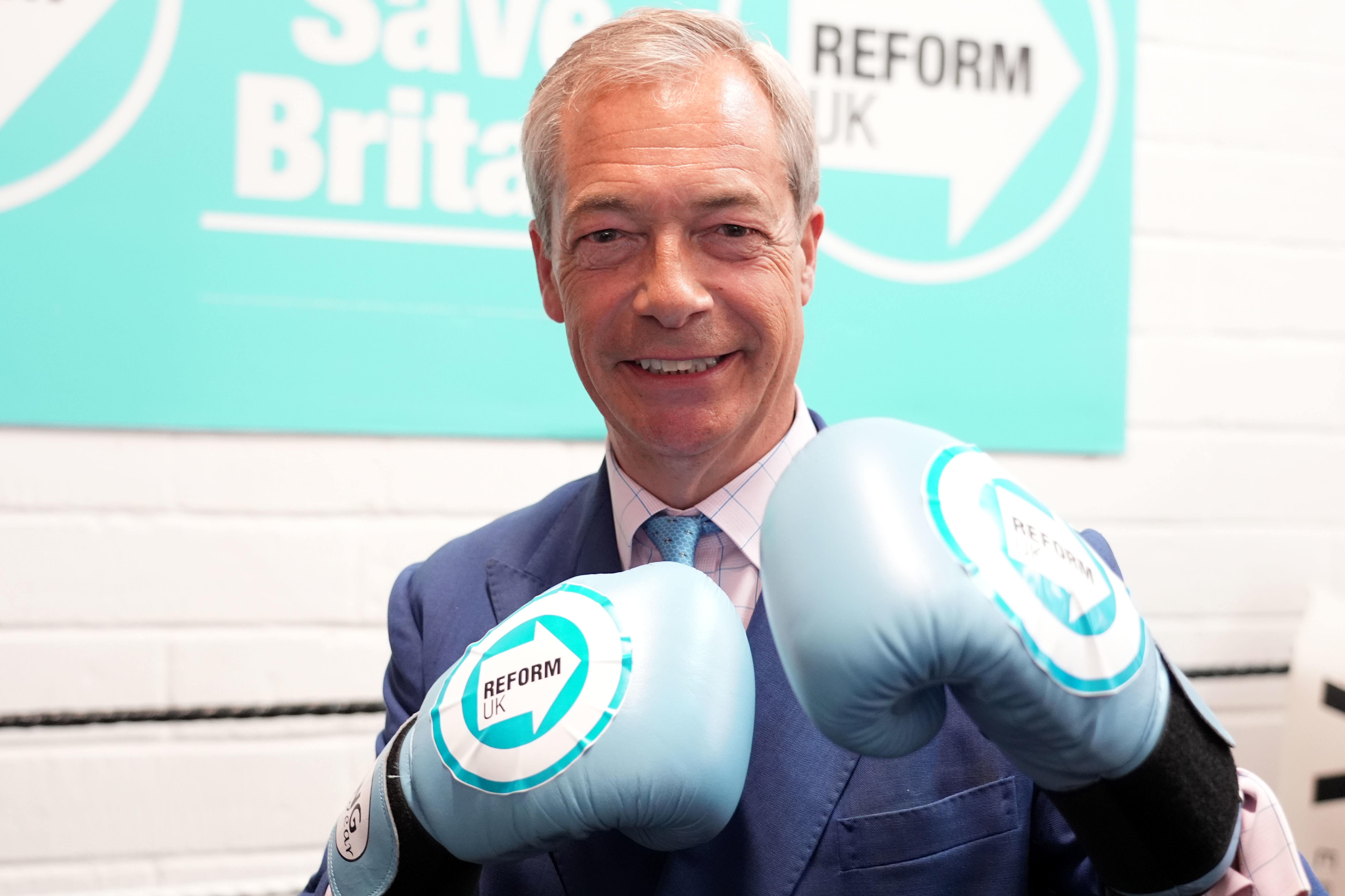 Reform UK leader Nigel Farage wearing boxing gloves at a boxing gym in Clacton (Ian West/PA)