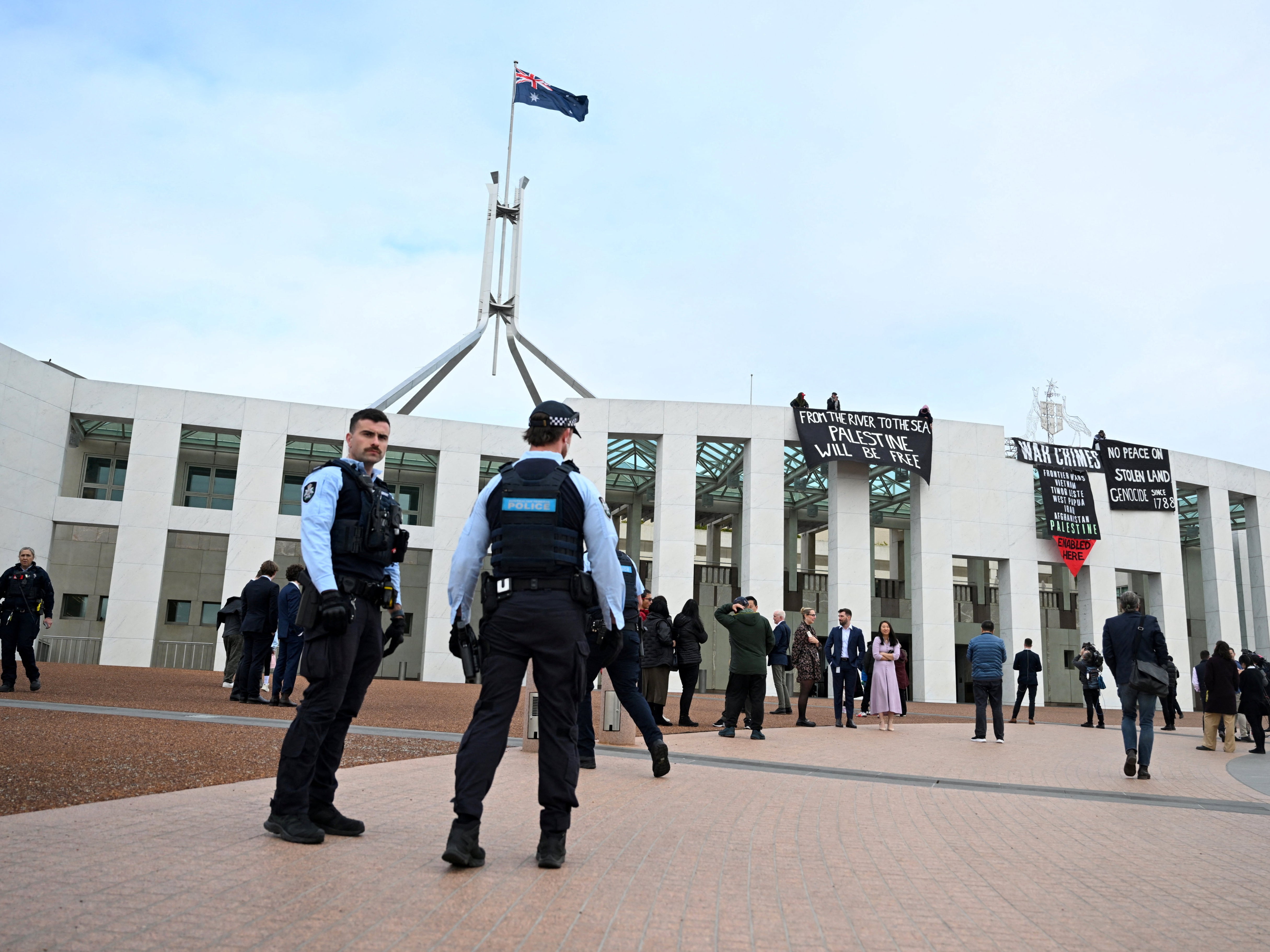 Pro-Palestinian protesters hang banners from the top of Australia’s parliament in Canberra on 4 July 2024