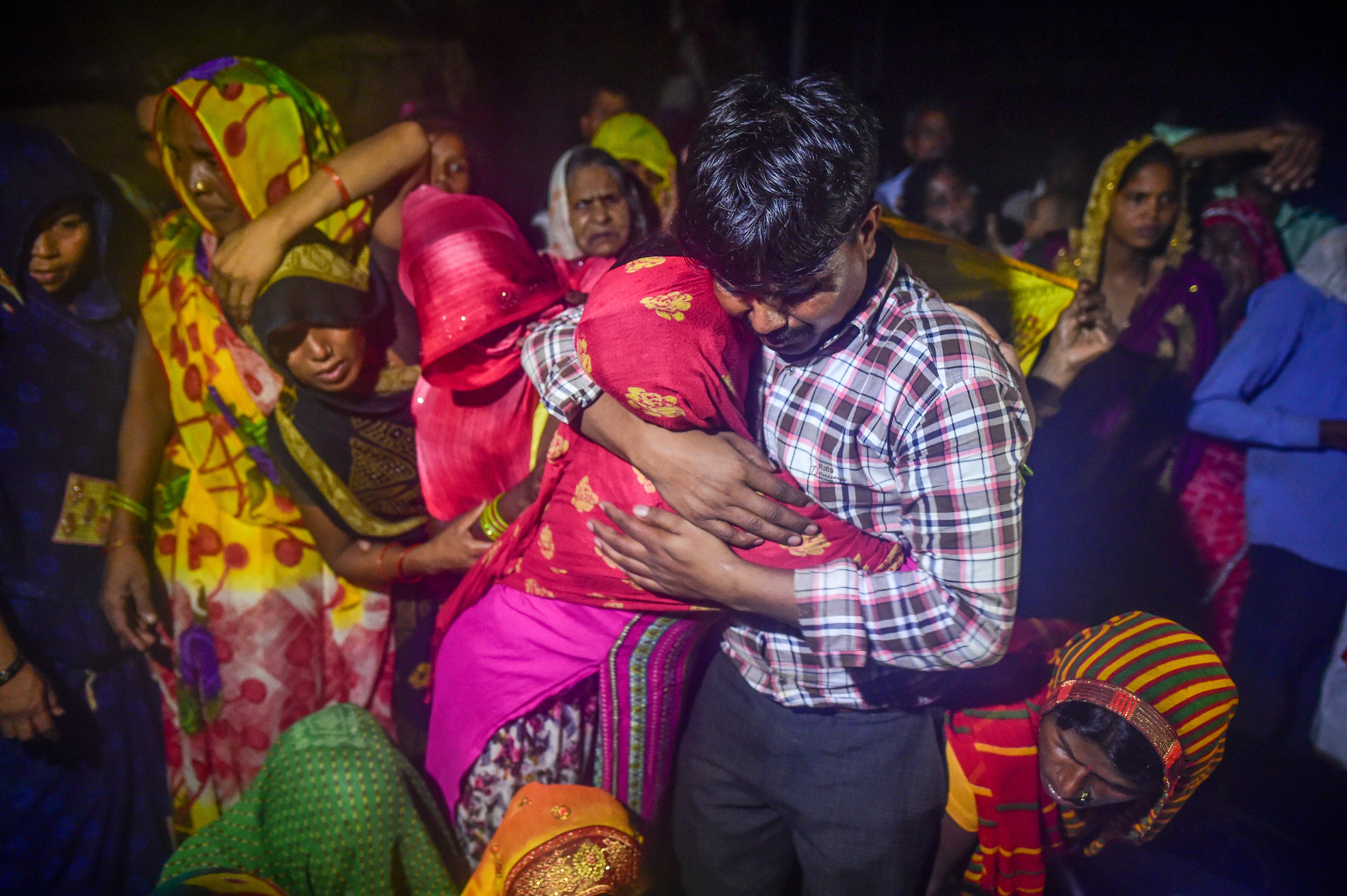 Relatives and villagers in Daukeli village mourn those who died in a stampede during a cremation ceremony in Hathras, Uttar Pradesh