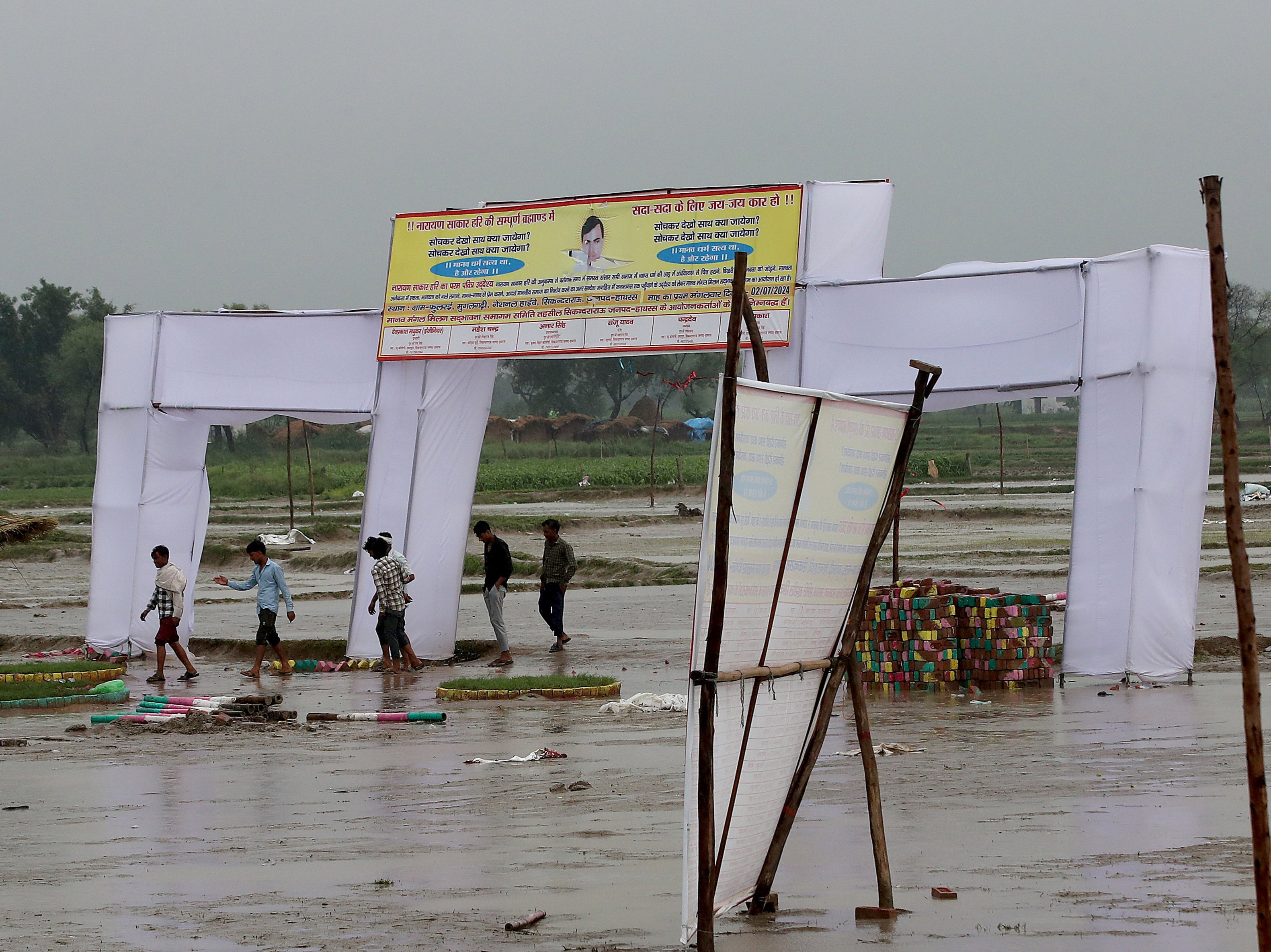 People walk at the scene after a stampede in Hathras, Uttar Pradesh