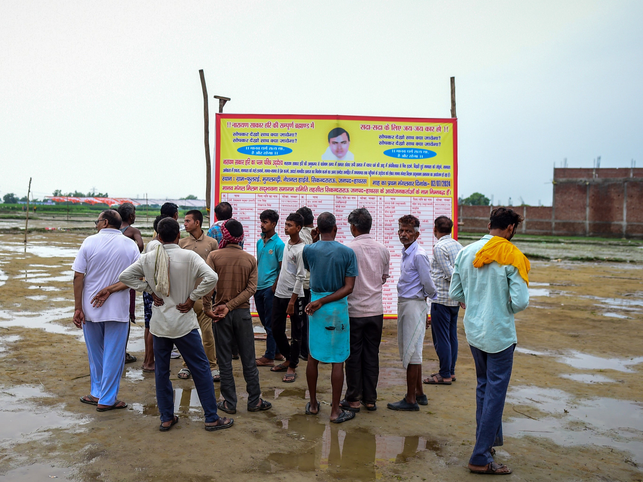 People walk around the venue of the stampede a day after it occurred on 3 July 2024 in Hathras, India