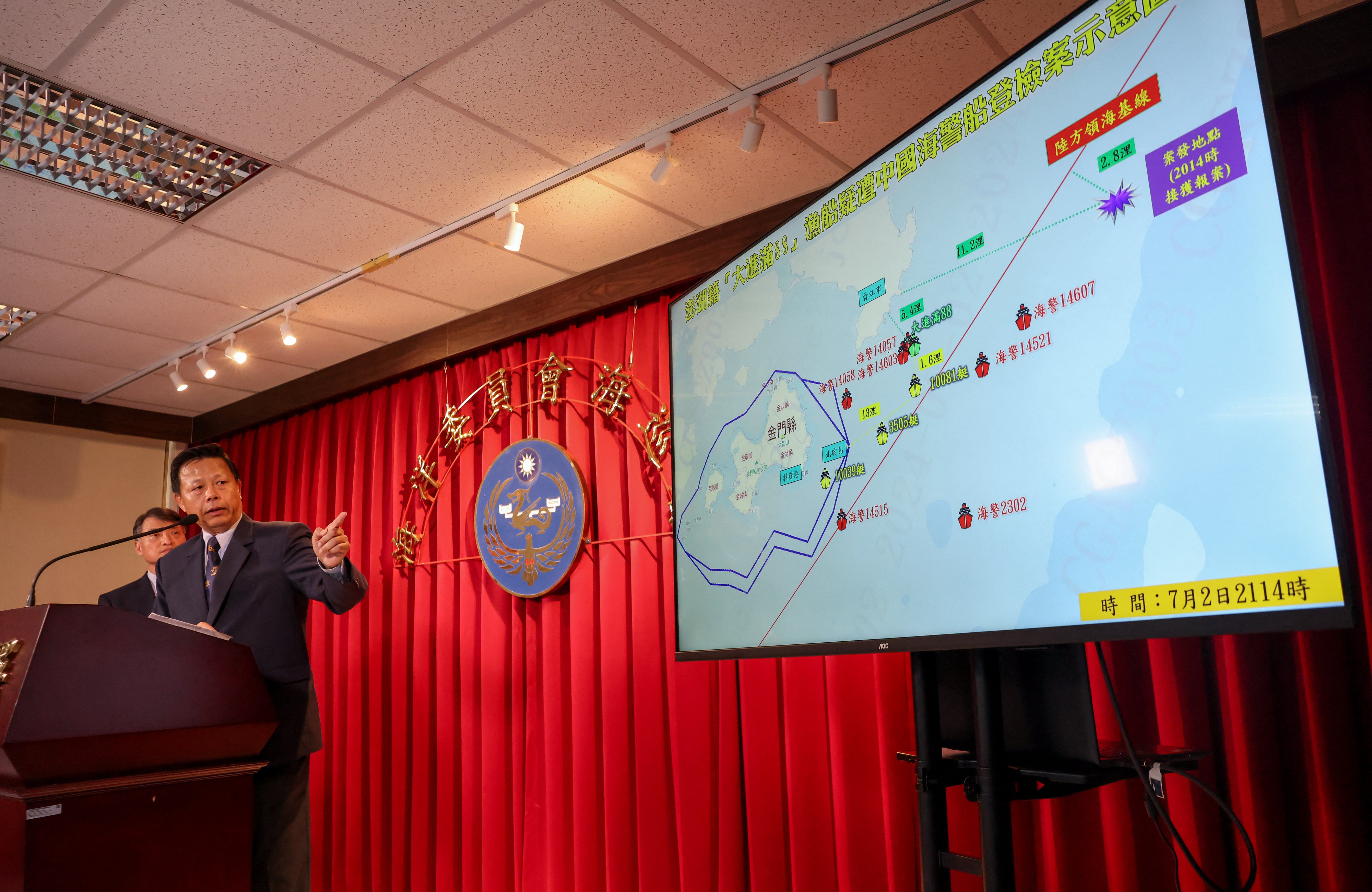 Taiwan Coast Guard Administration official Ching-Chin Hsieh explains the case of a fishing boat seized by China’s coast guard during a news conference in Taipei