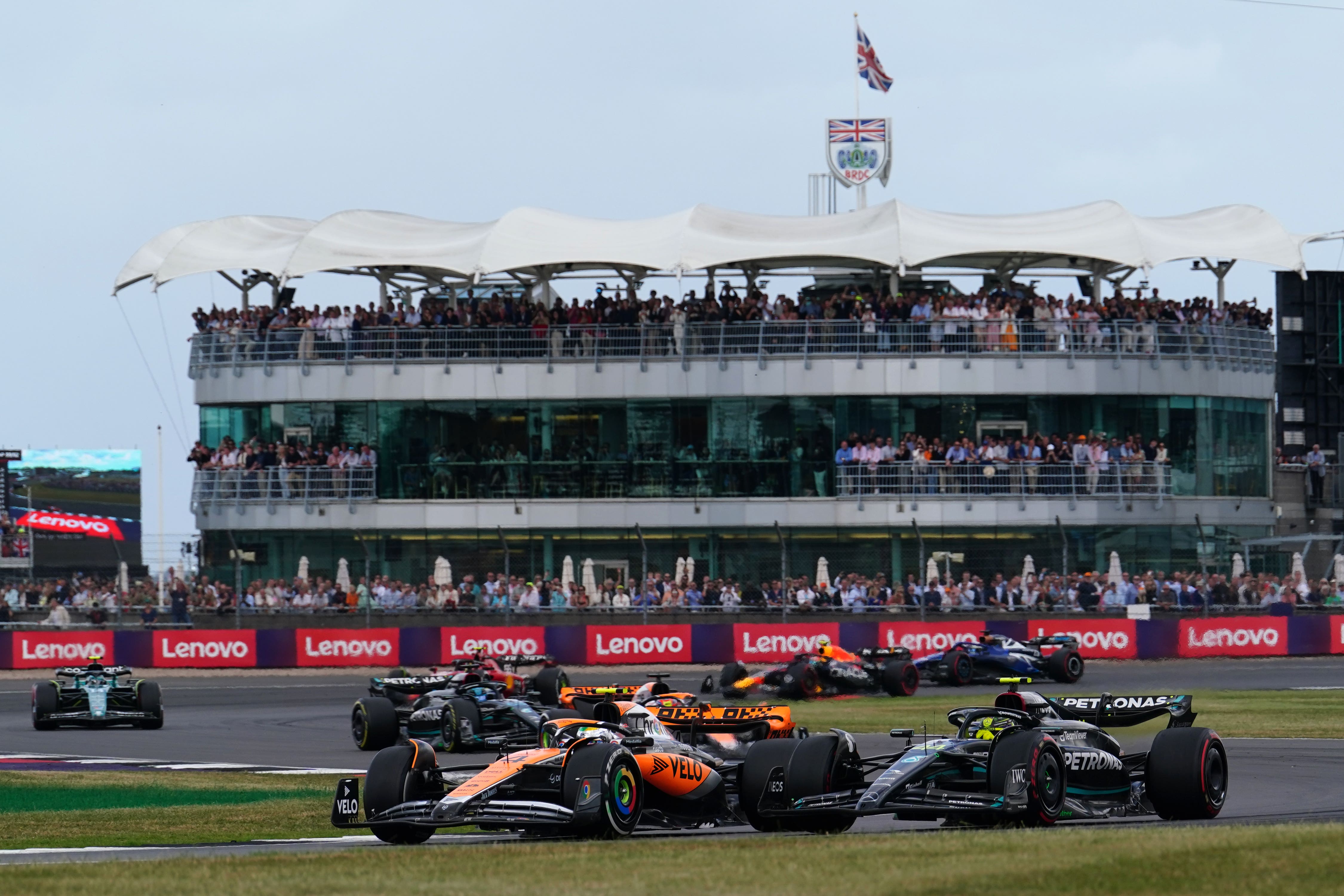 McLaren’s Lando Norris leads Mercedes’ Lewis Hamilton around Luffield in the 2023 British Grand Prix (David Davies/PA)