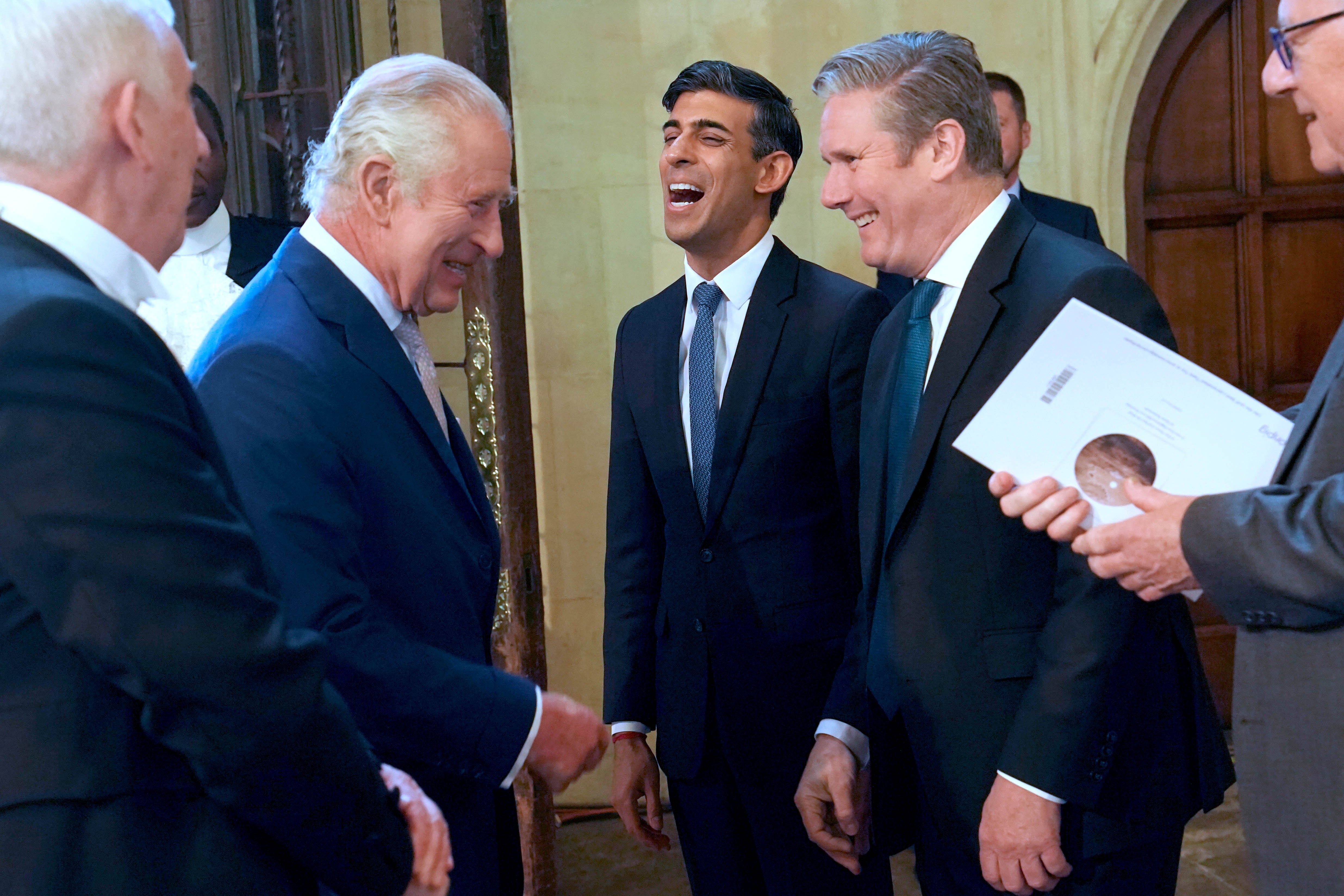 King Charles III speaking with Rishi Sunak and Starmer at an event in 2023