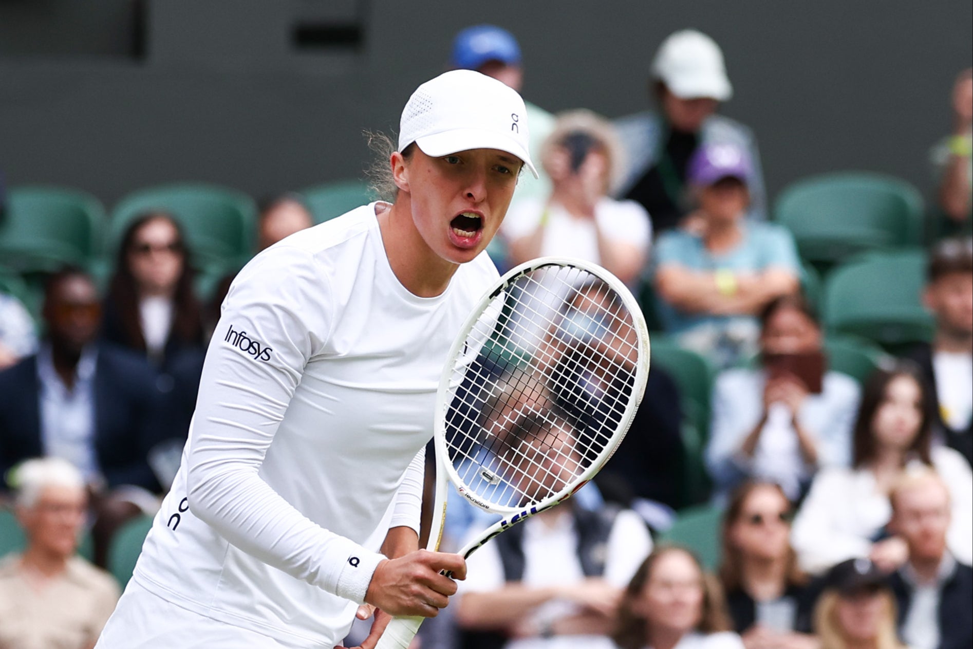 Iga Swiatek celebrates winning match point against Petra Martic