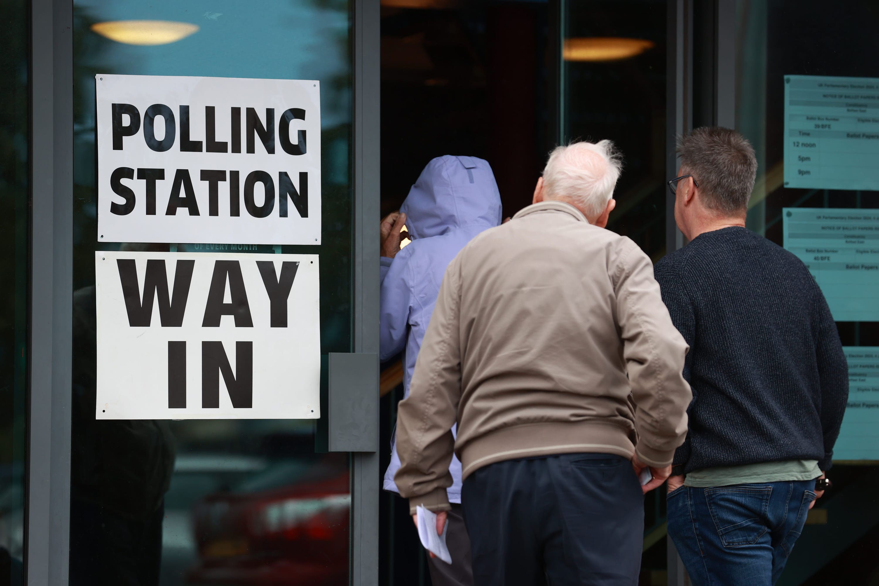 People arrive to cast their votes in the 2024 General Election at St Colmcille’s Church in east Belfast (Liam McBurney/PA)