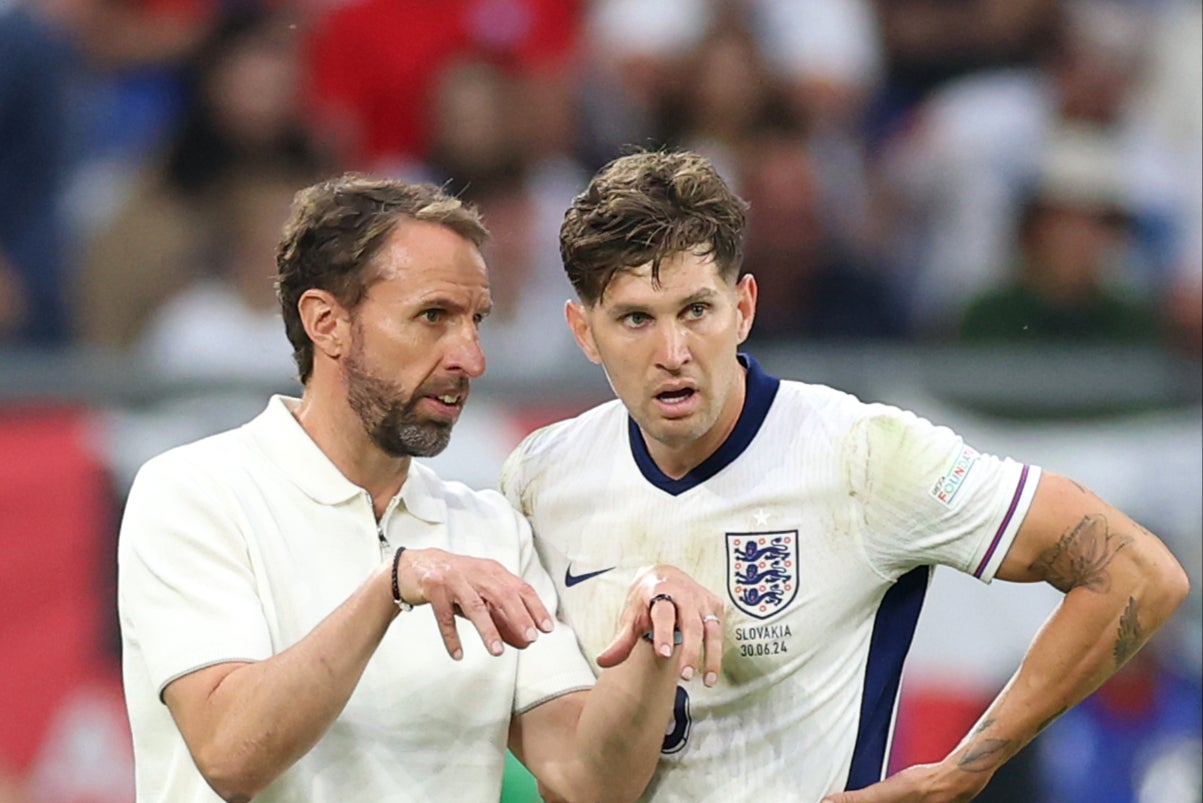 John Stones (right) discussing tactics with England manager Gareth Southgate