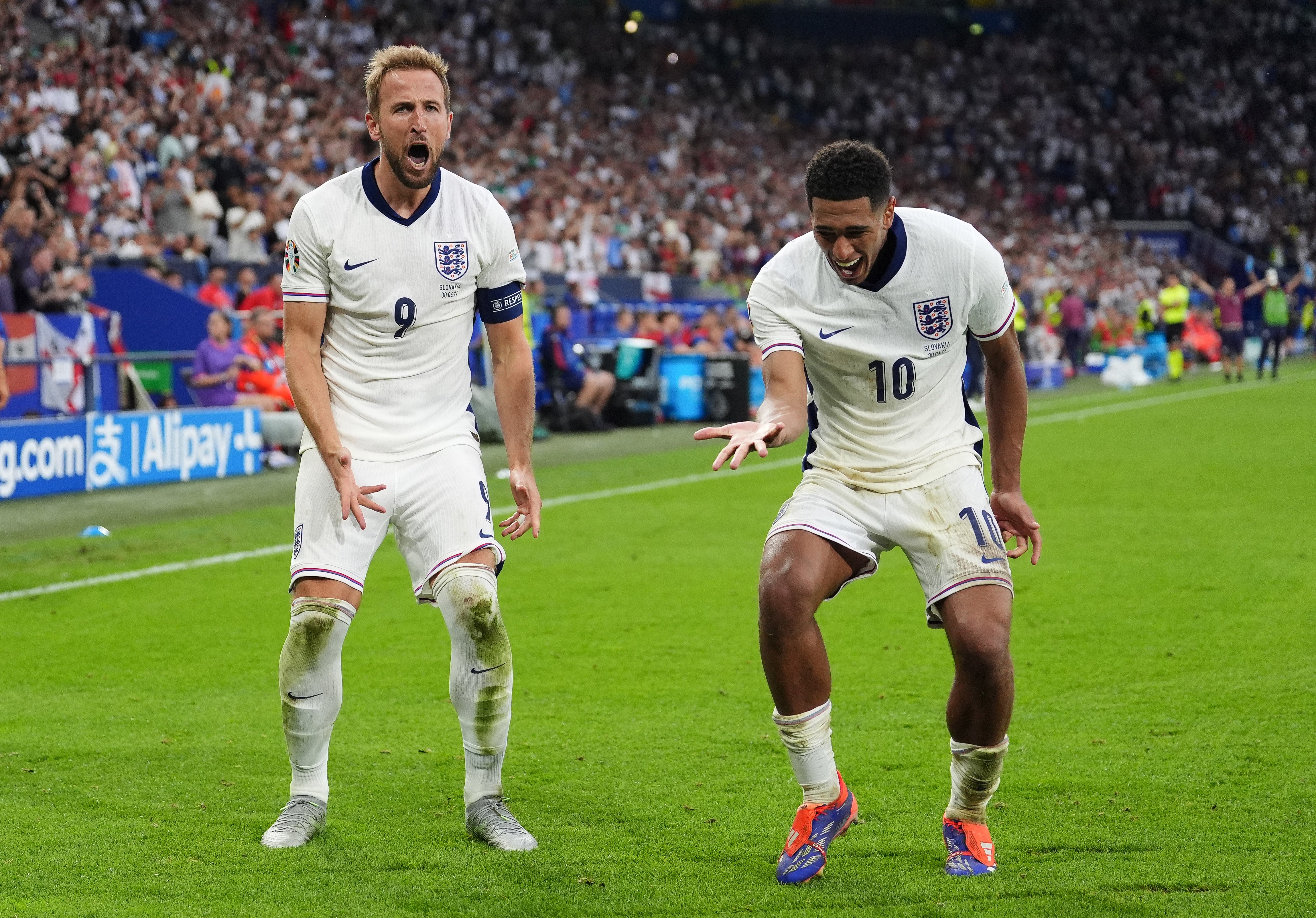 Harry Kane celebrates with Jude Bellingham after scoring England’s second goal against Slovakia (Bradley Collyer/PA)