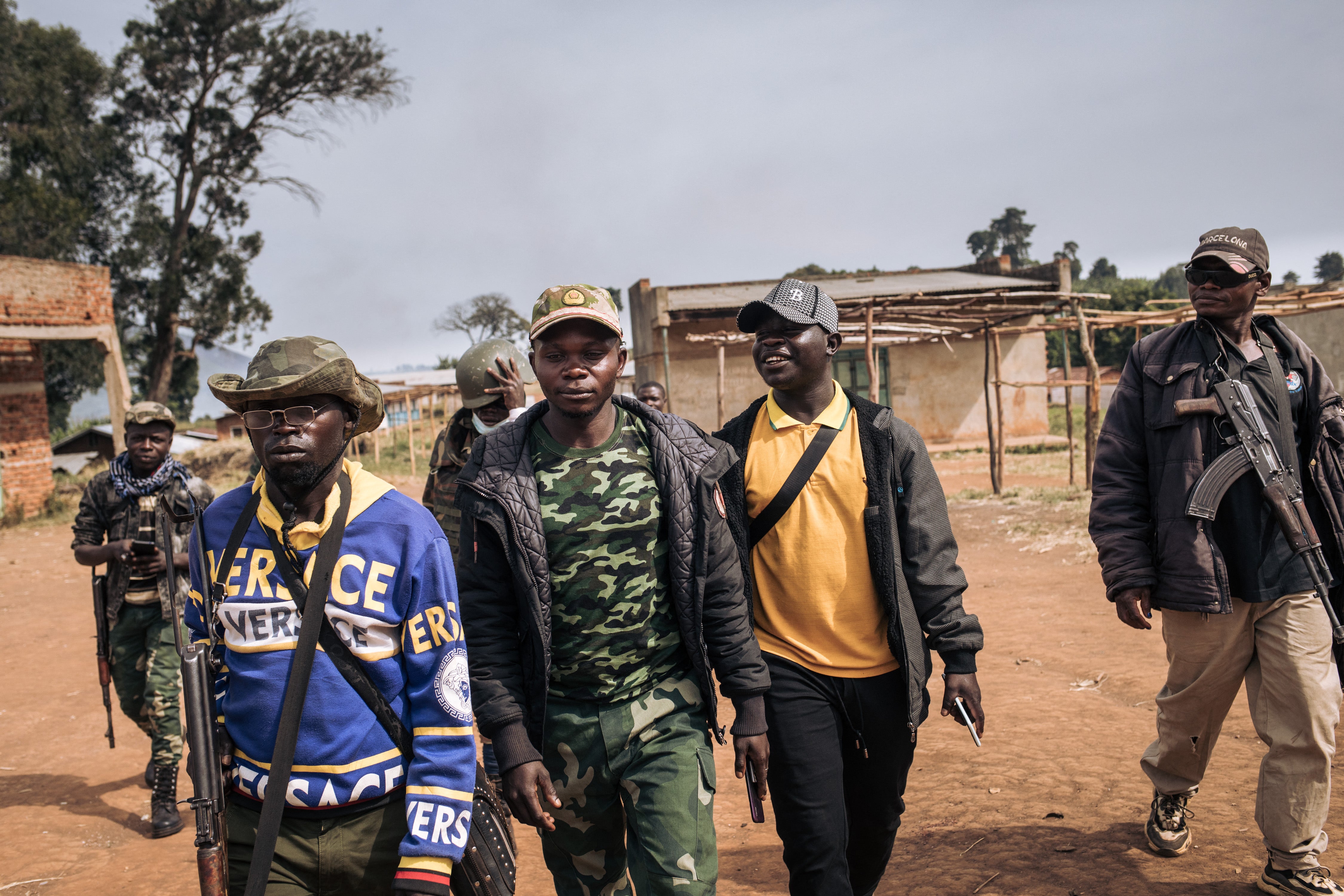 Commanders of the militia group Codeco walk through Linga village in Ituri province of Congo