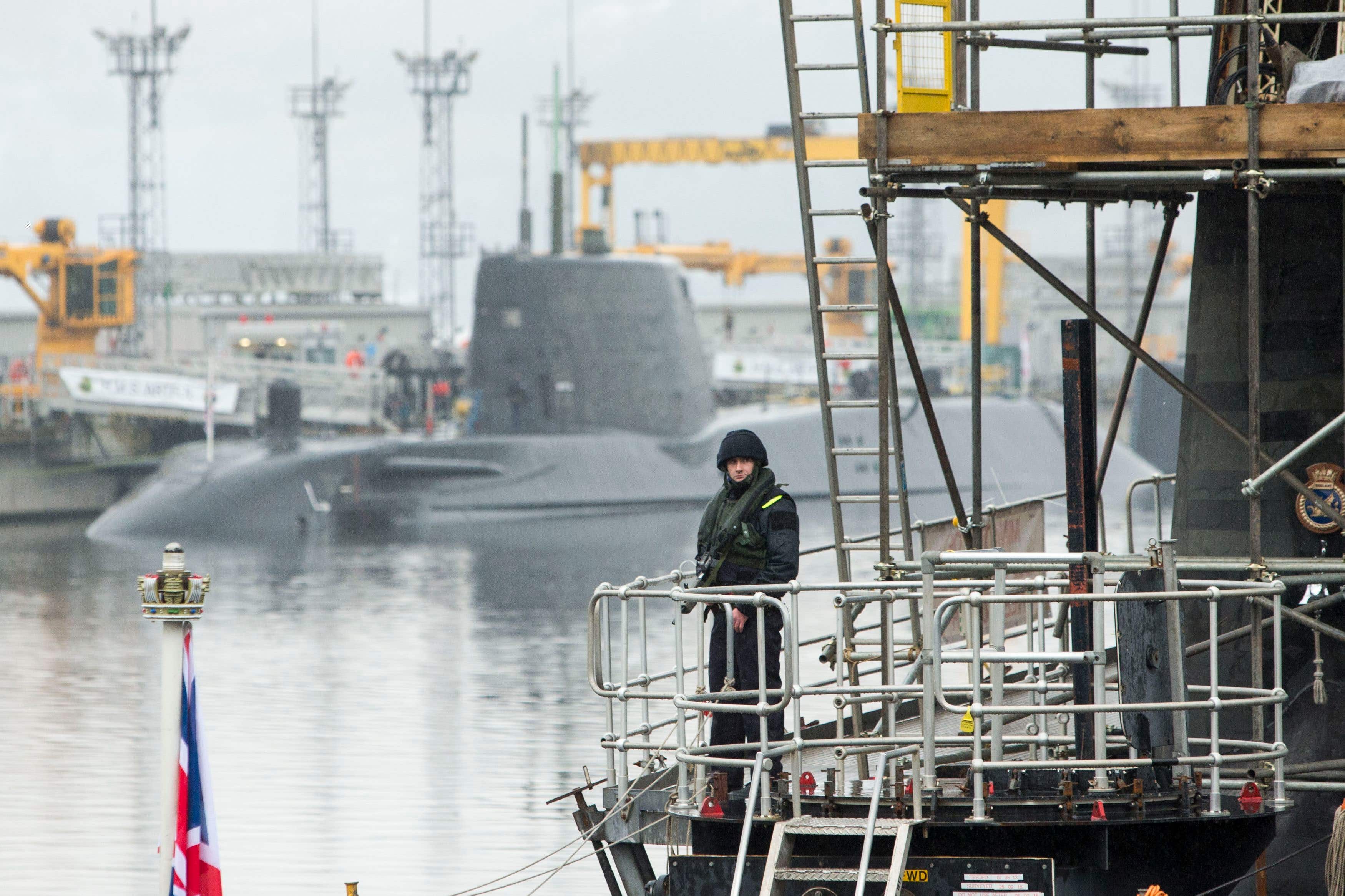 A member of the armed services on the deck of Vanguard-class submarine HMS Vigilant, one of the UK’s four nuclear warhead-carrying submarines (Danny Lawson/PA)