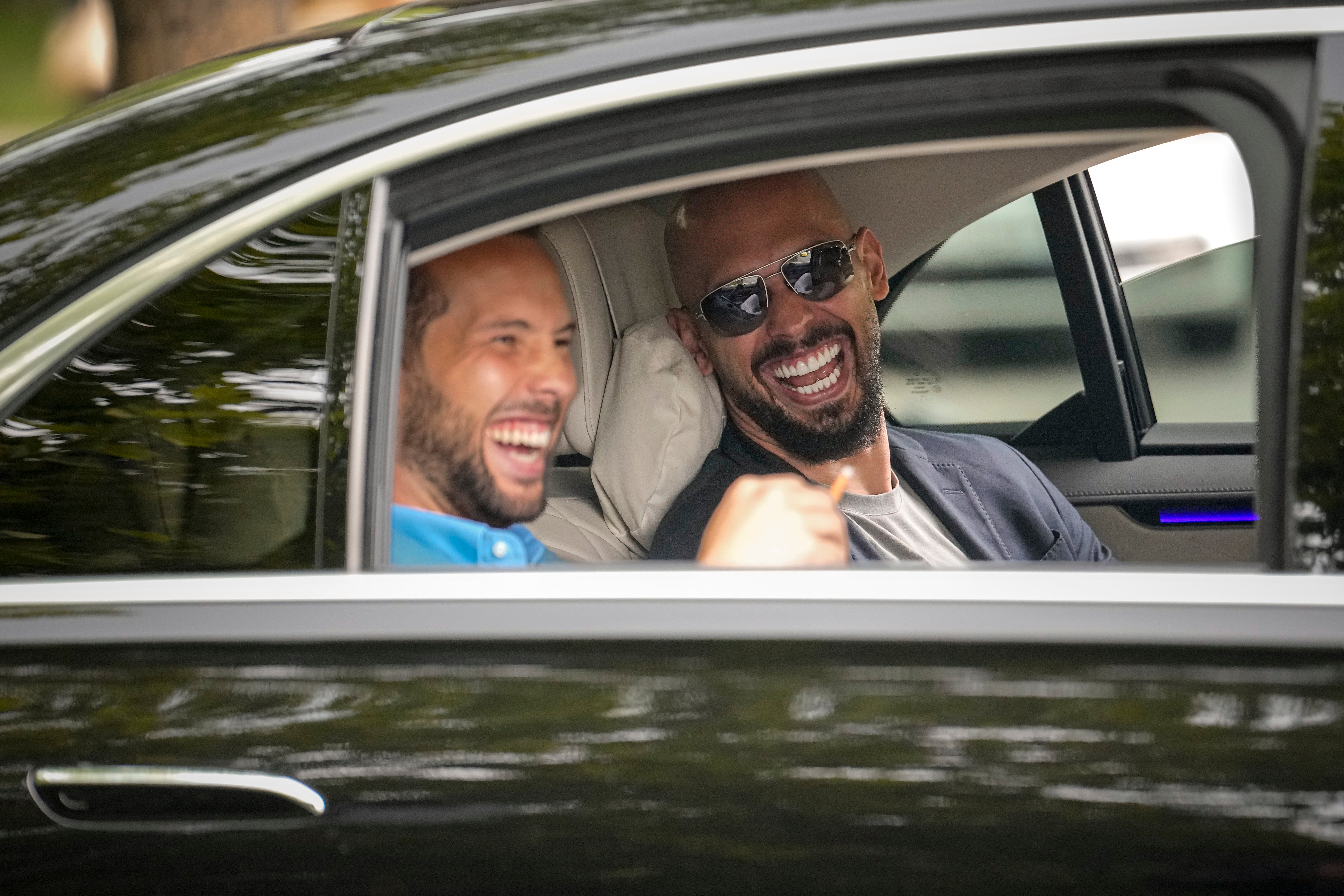 Andrew Tate, right, and his brother Tristan laughed as they left the Tribunal in Bucharest, Romania, in May