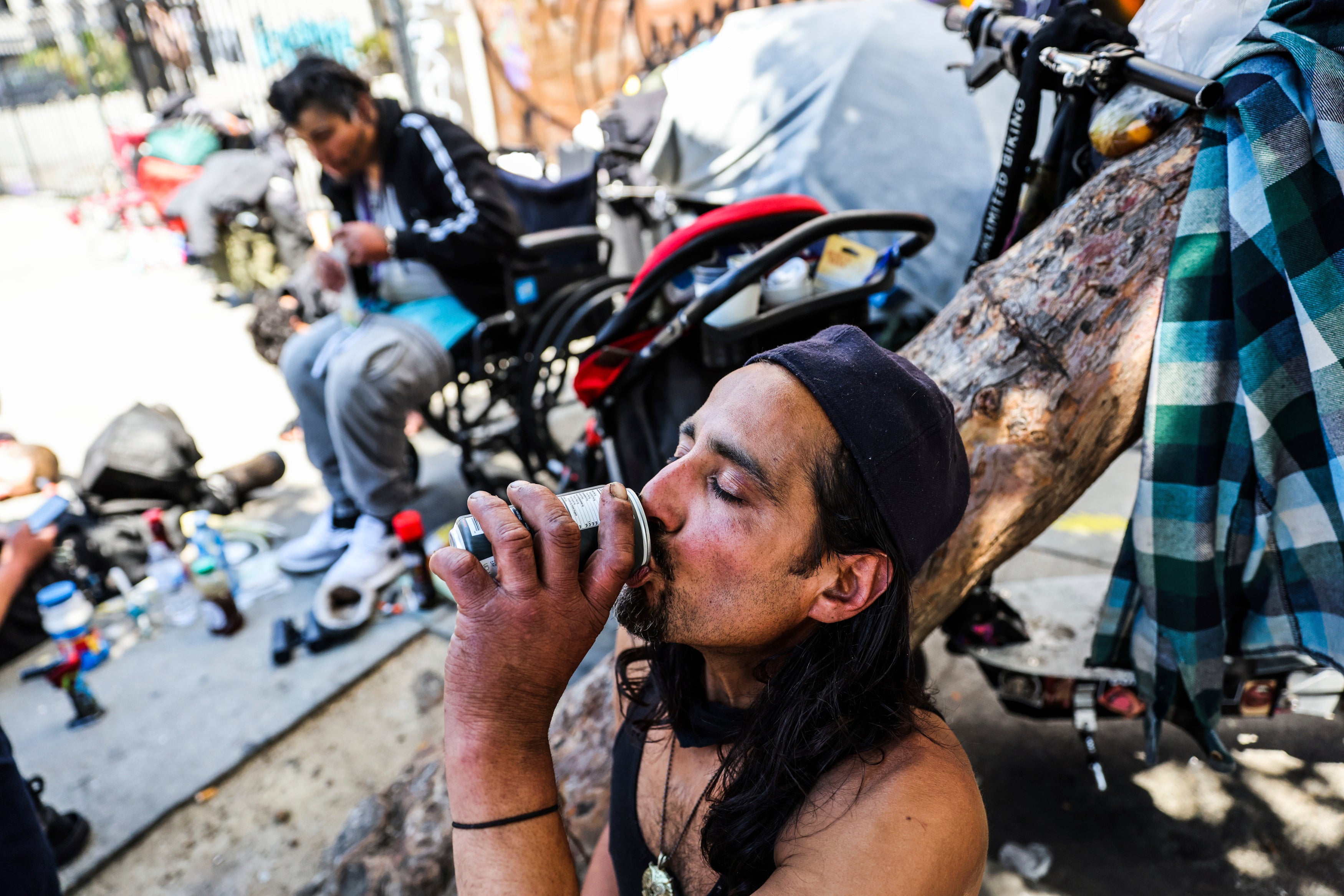 A homeless man named Angel drinks a soda to keep cool during a heatwave in San Francisco on July 3