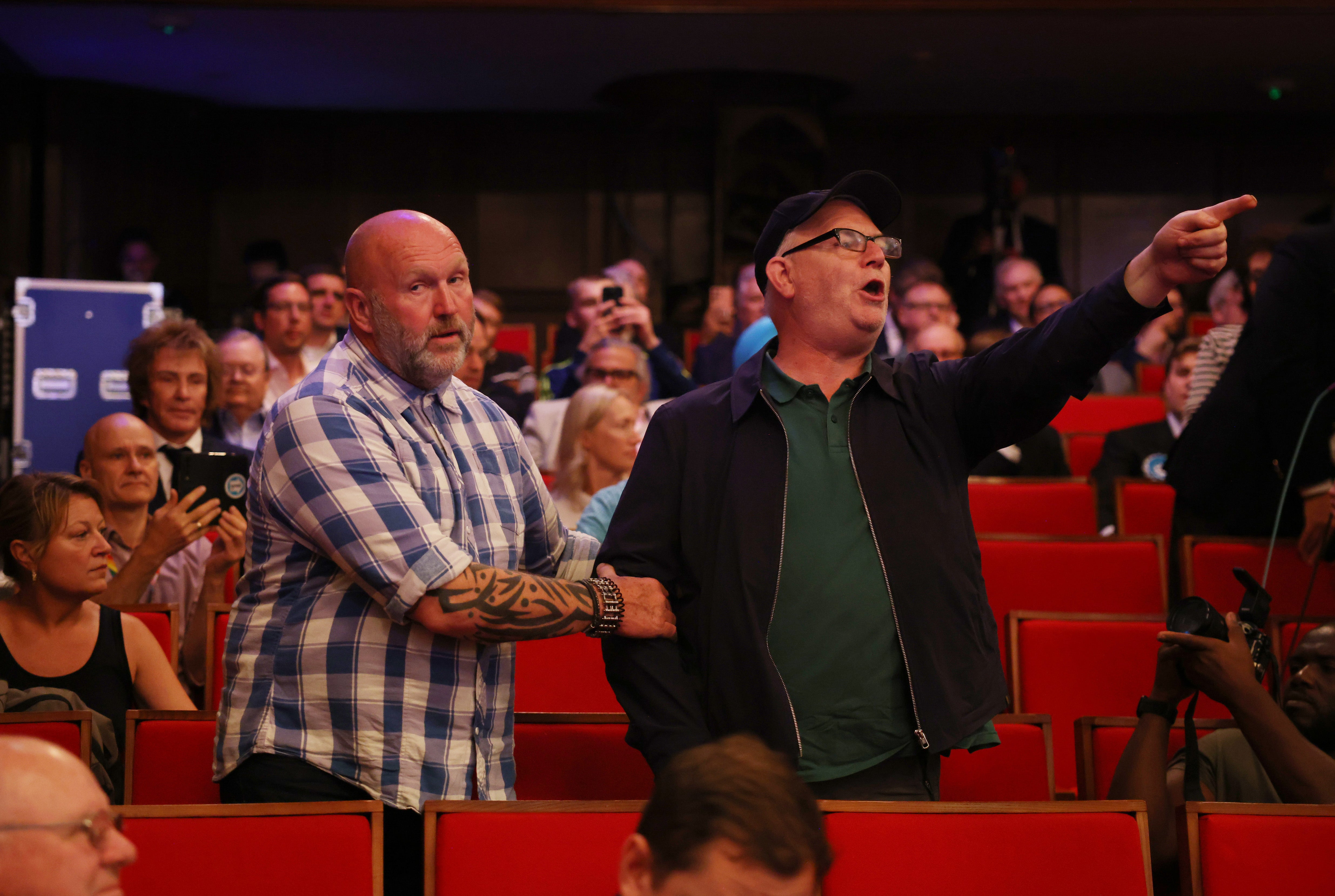 A heckler is removed by security after disrupting the Reform leader’s speech