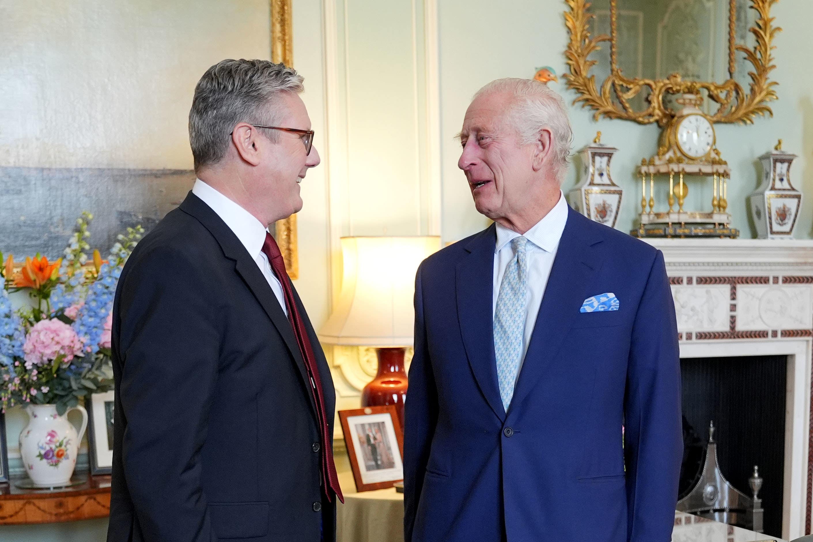 The King speaks with Sir Keir Starmer during an audience at Buckingham Palace where he invited him to become prime minister and form a new government (