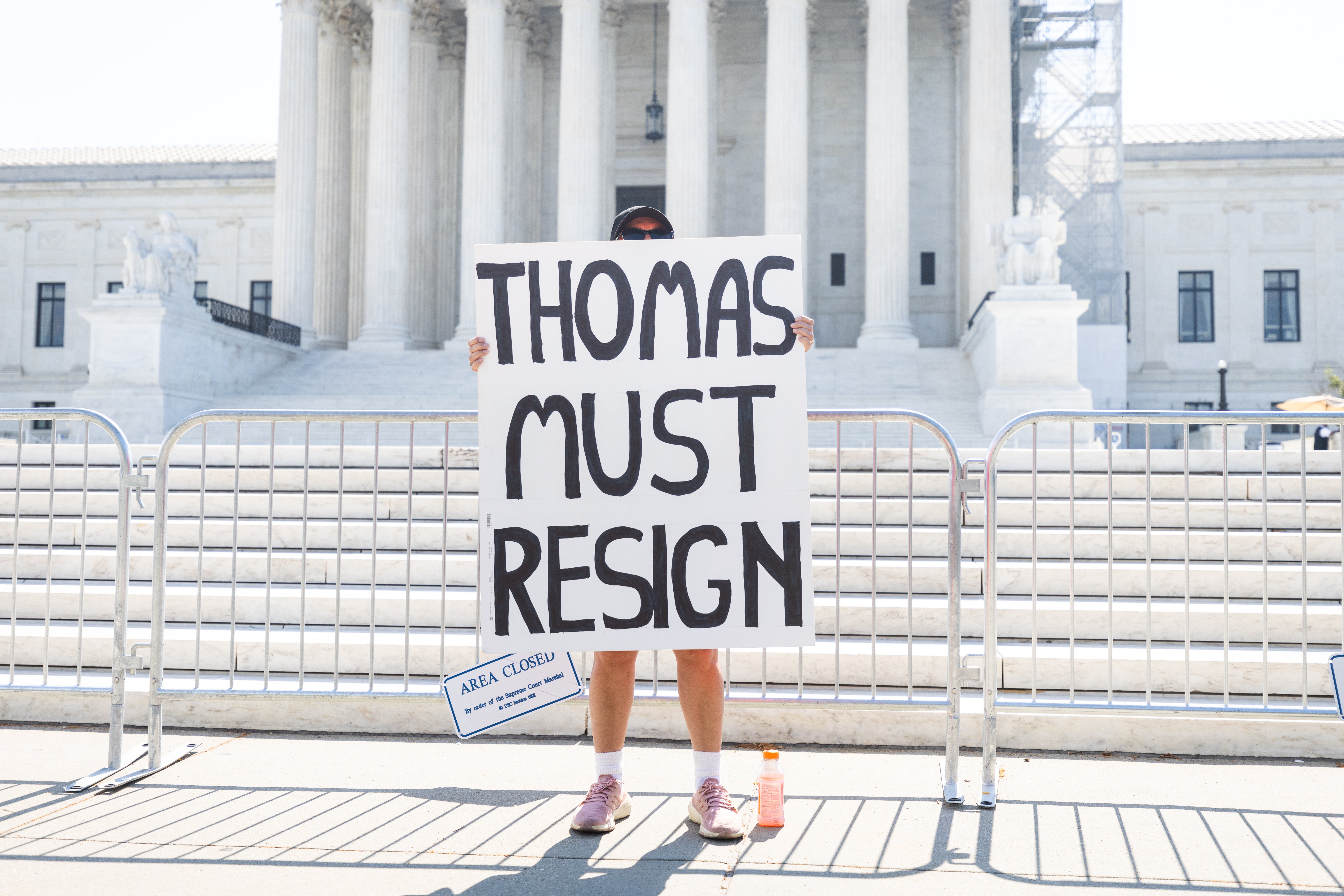 A protester calls on Justice Clarence Thomas to resign from the Supreme Court on June 14.