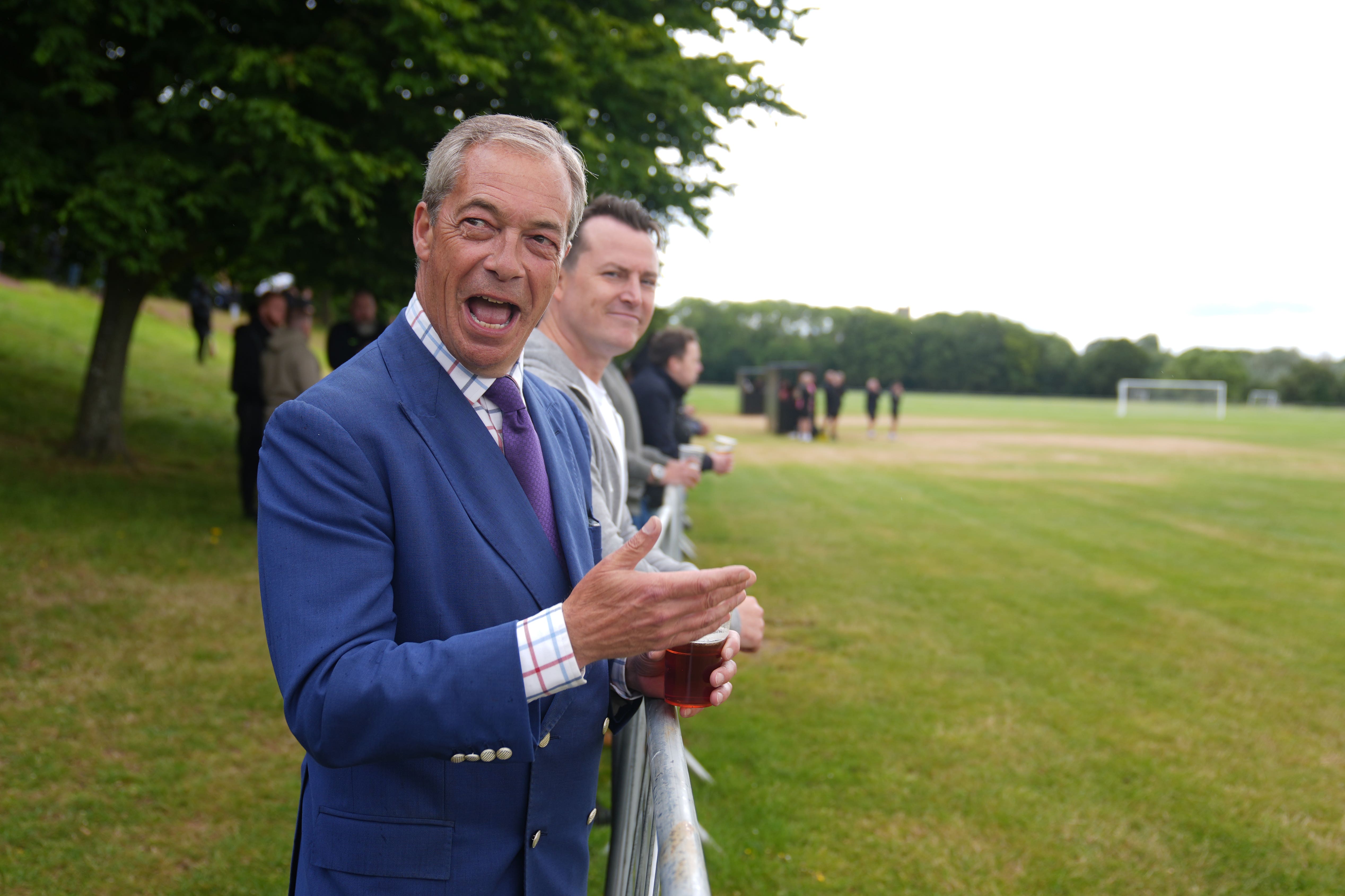 Reform UK leader Nigel Farage and the new Reform MP for South Basildon and East Thurrock, James McMurdock, watch the inaugural match of East Thurrock CFC at Wyldecrest Sports Country Club, Corringham, Essex. Picture date: Saturday July 6, 2024. (Joe Giddens/PA)