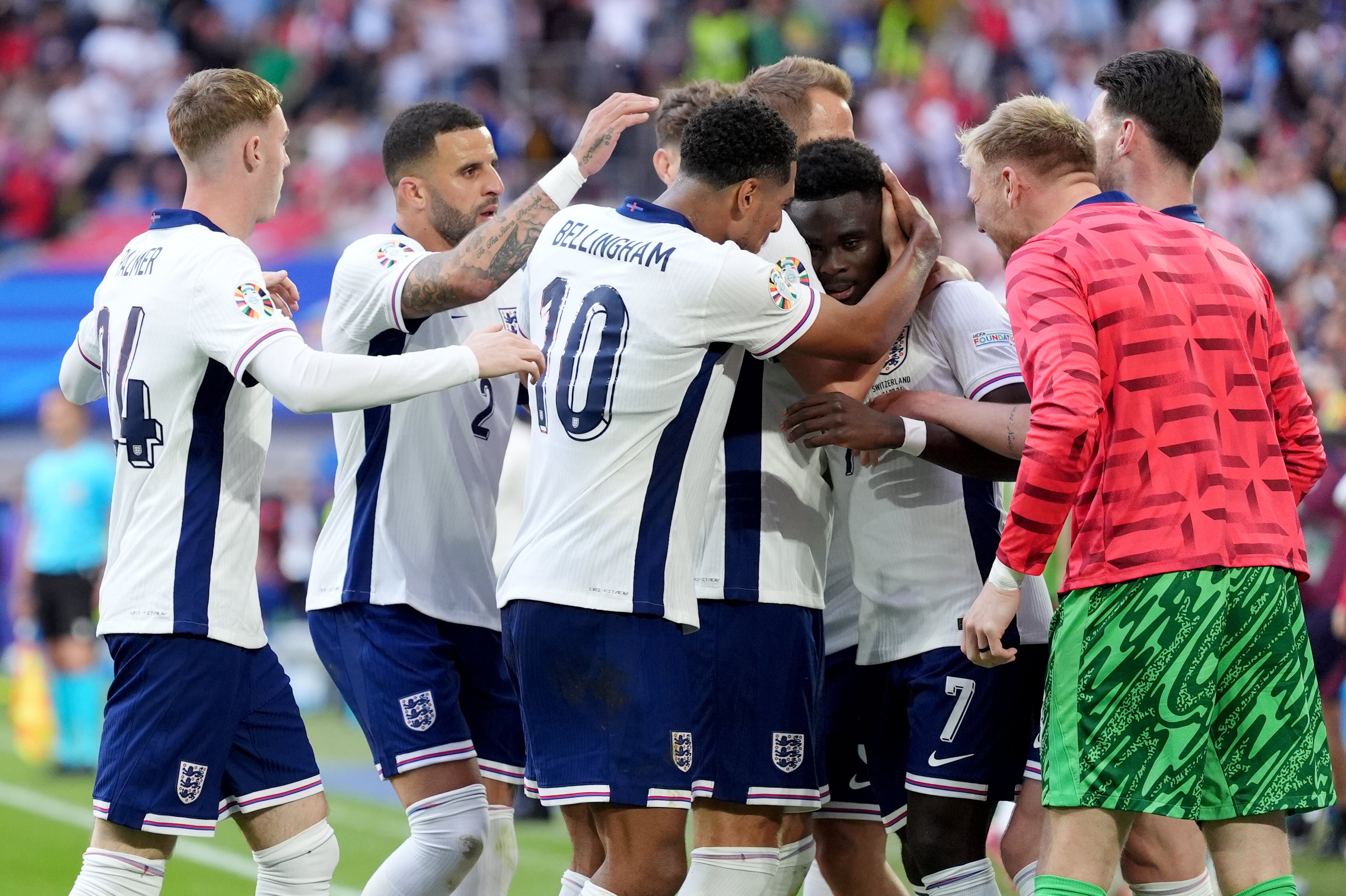 England players thanking Saka for his vital equaliser