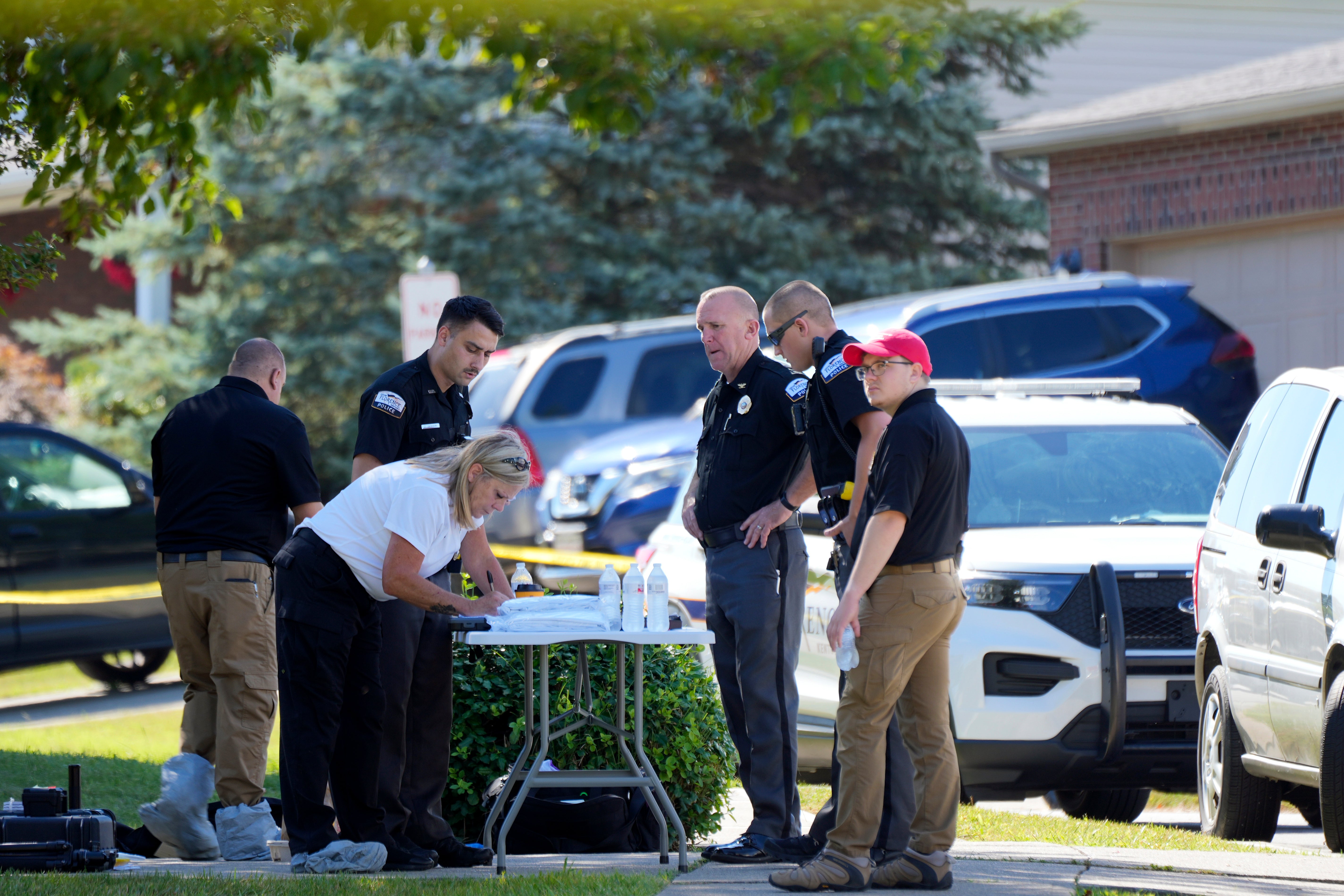 Police investigate the scene after responding to a shooting in Florence